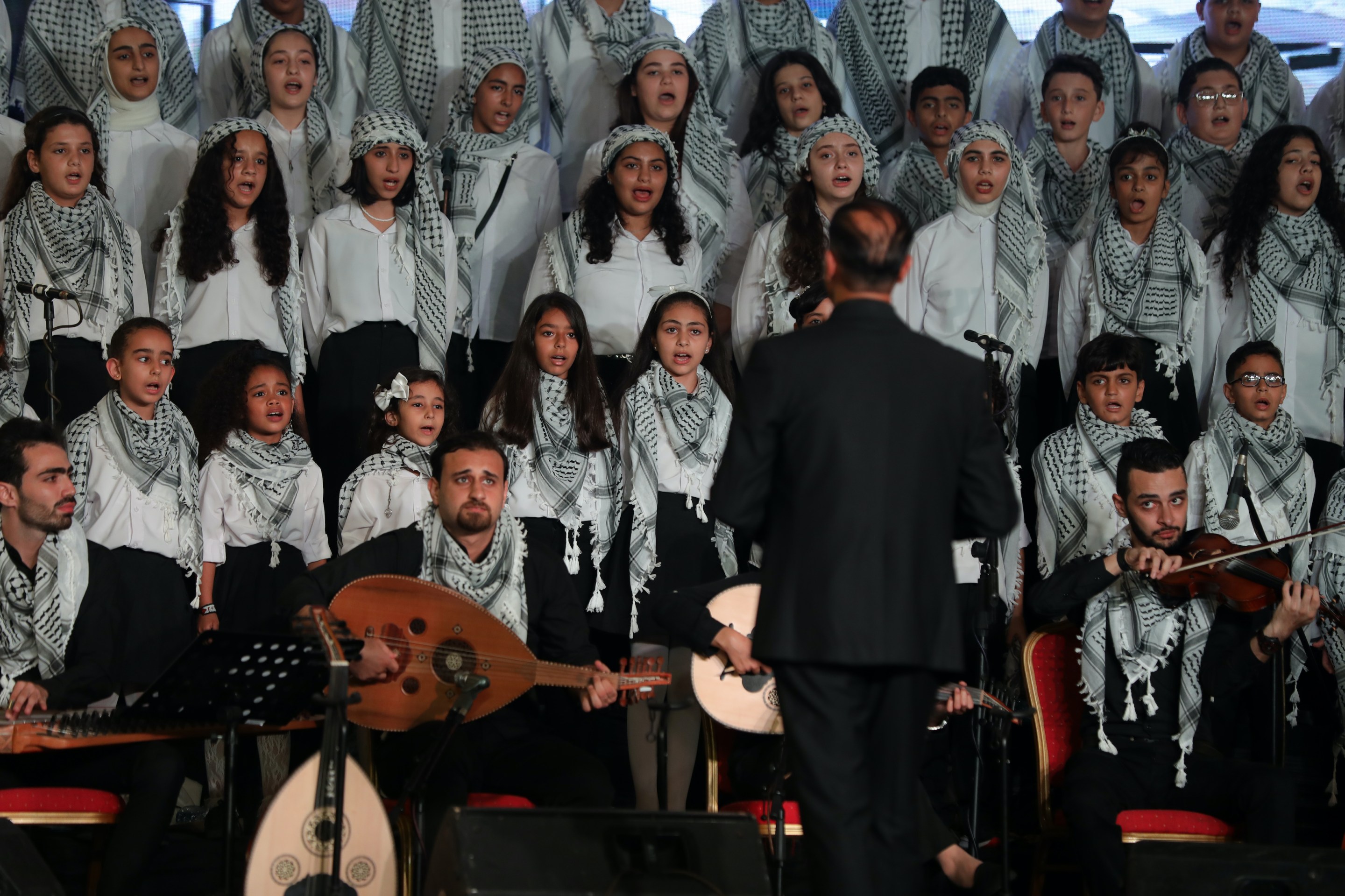 Young Palestinian choir members, attending an UNRWA-funded school, sing during a performance on July 18, 2023, in Gaza City.