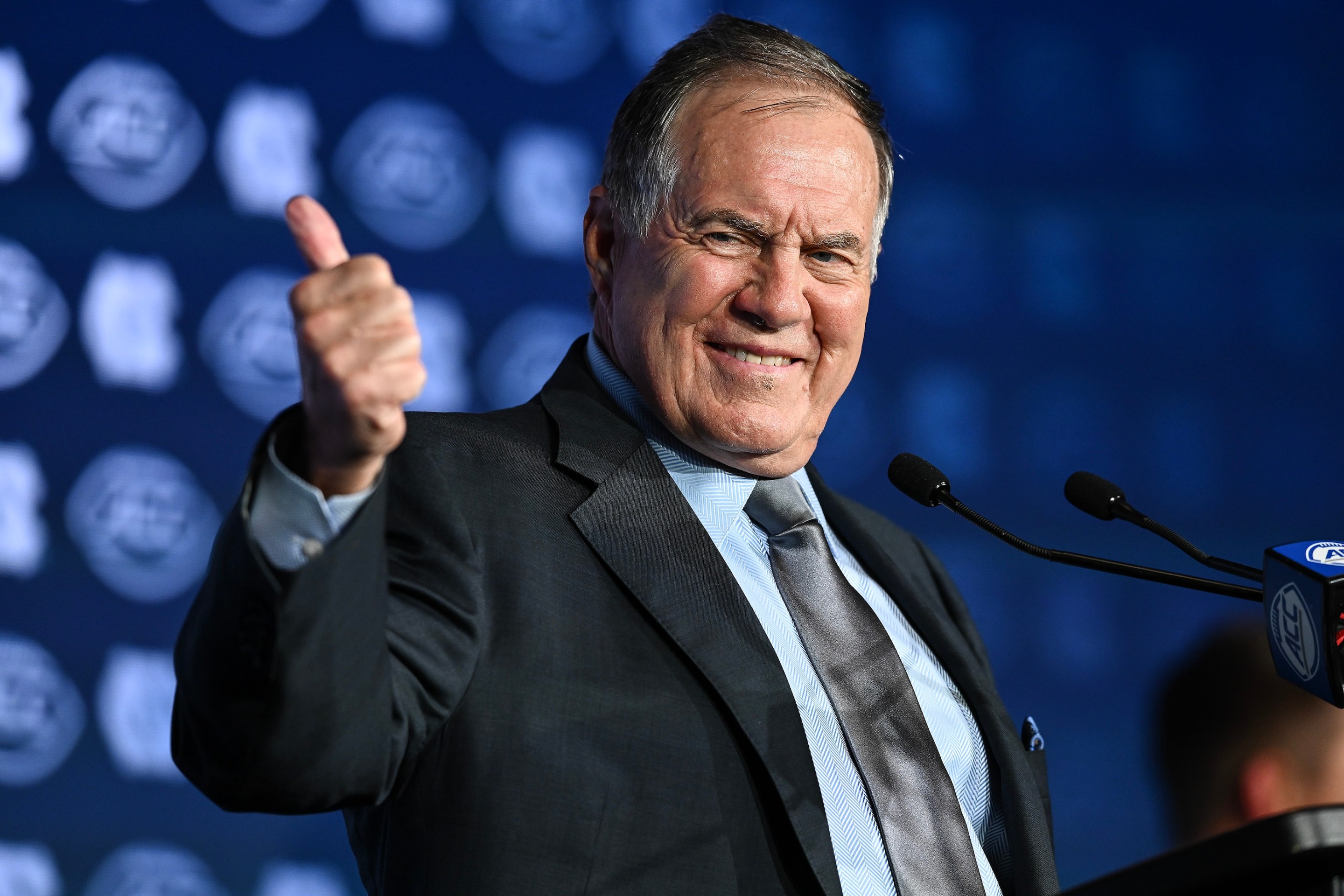 Head coach Bill Belichick of the North Carolina Tar Heels gives a thumbs up during the ACC Football Kickoff at Hilton Charlotte Uptown on July 24, 2025 in Charlotte, North Carolina. He looks real weird doing it.