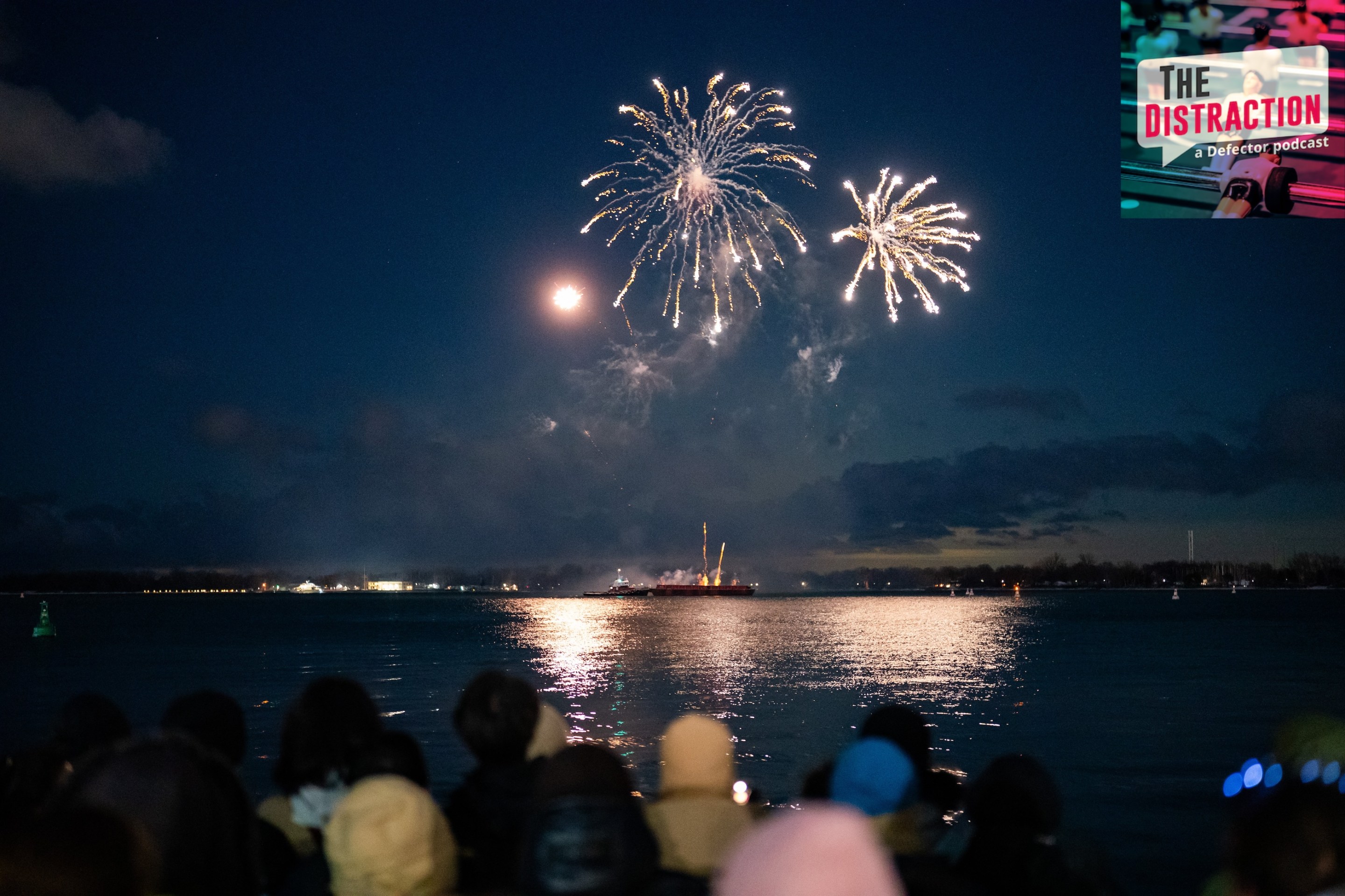 People take in a fireworks show on Lake Ontario at midnight from HTO Park in Toronto on January 1 2026.