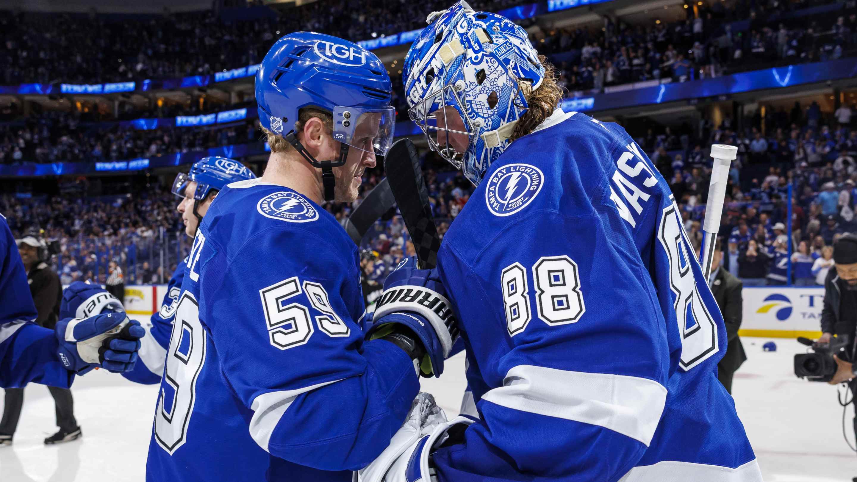 Jake Guentzel #59 and Andrei Vasilevskiy #88 of the Tampa Bay Lightning celebrate the win against the Colorado Avalanche