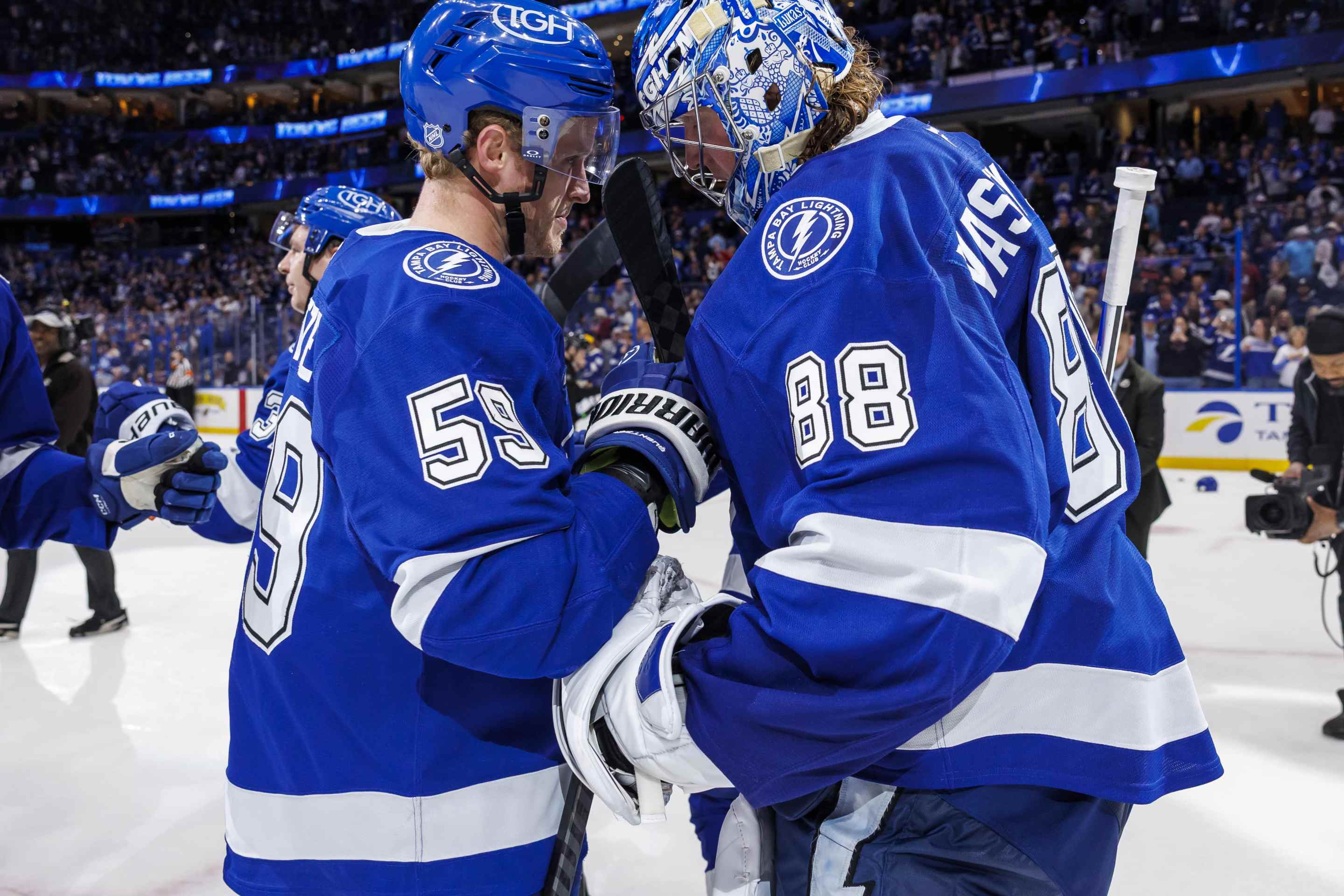 Jake Guentzel #59 and Andrei Vasilevskiy #88 of the Tampa Bay Lightning celebrate the win against the Colorado Avalanche