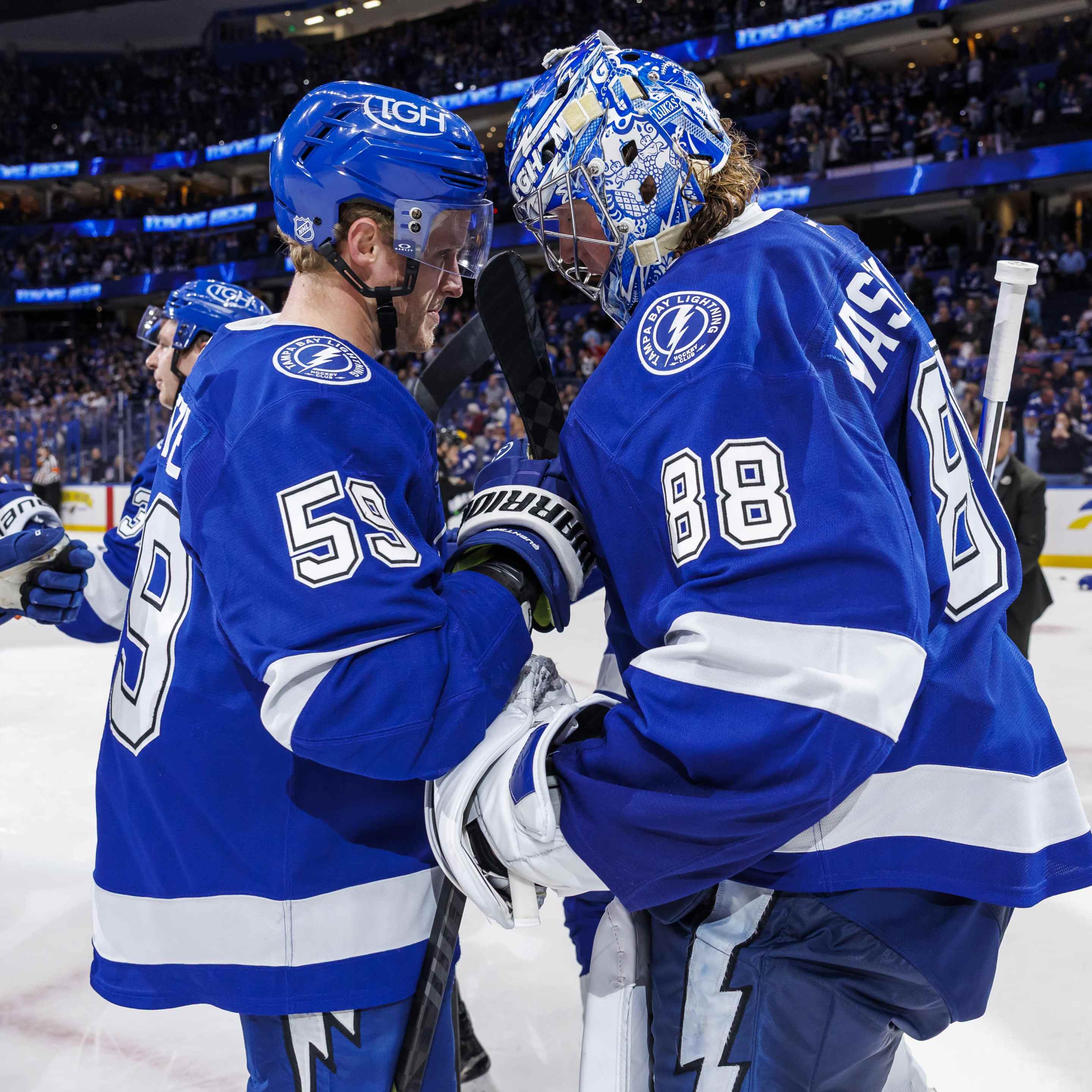 Jake Guentzel #59 and Andrei Vasilevskiy #88 of the Tampa Bay Lightning celebrate the win against the Colorado Avalanche