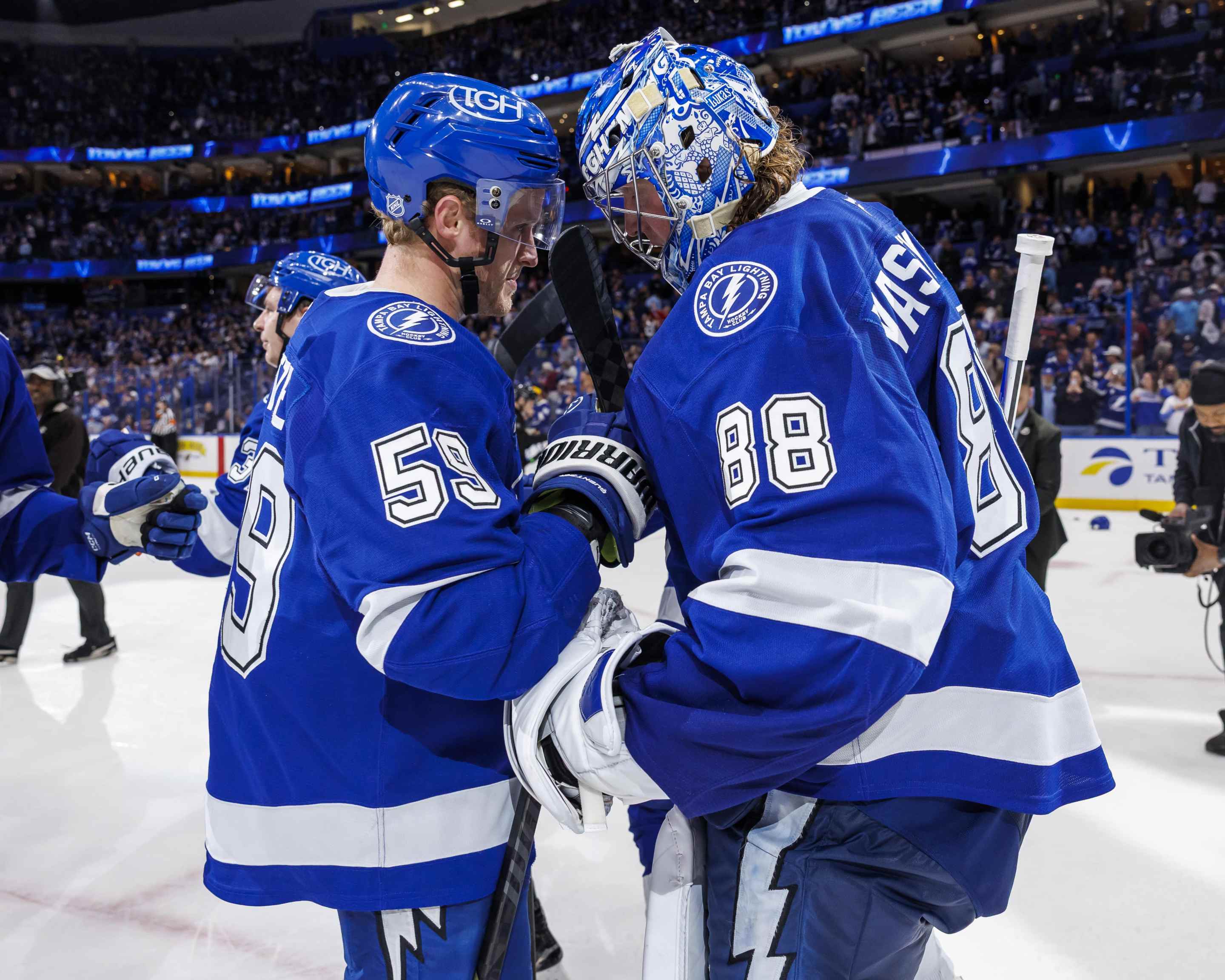 Jake Guentzel #59 and Andrei Vasilevskiy #88 of the Tampa Bay Lightning celebrate the win against the Colorado Avalanche