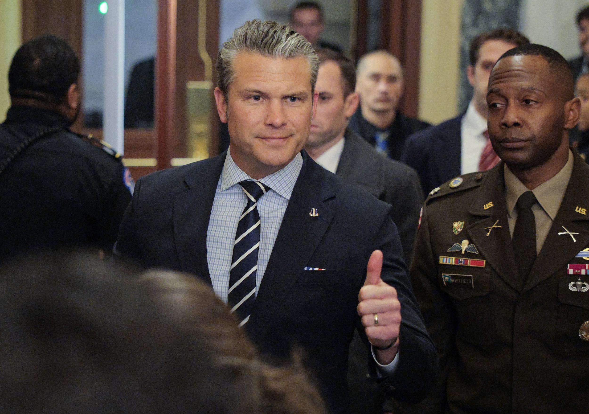 Pete Hegseth gives a thumbs up.