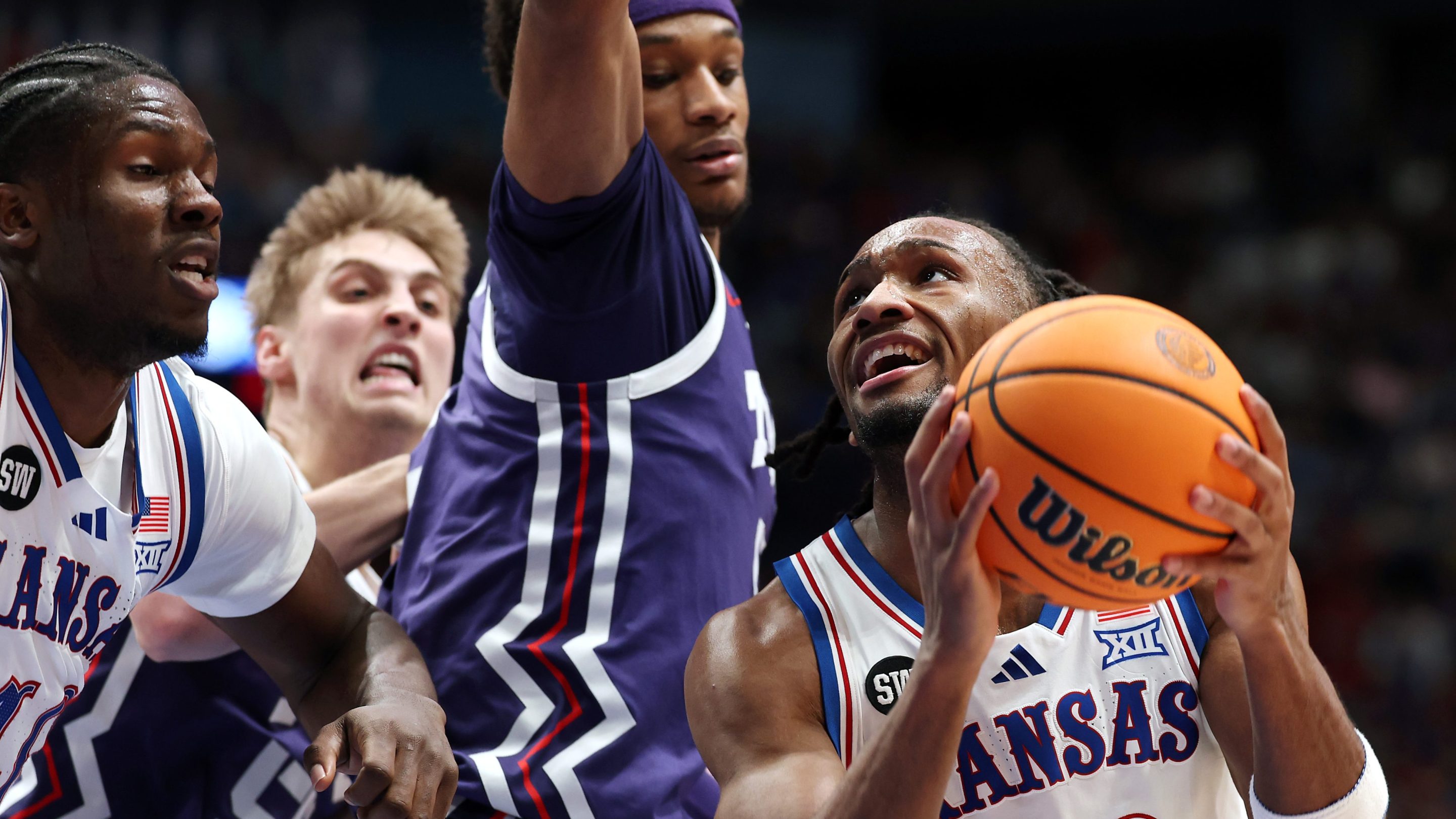 Darryn Peterson #22 of the Kansas Jayhawks looks to shoot as Micah Robinson #5 of the Texas Christian University Horned Frogs defends