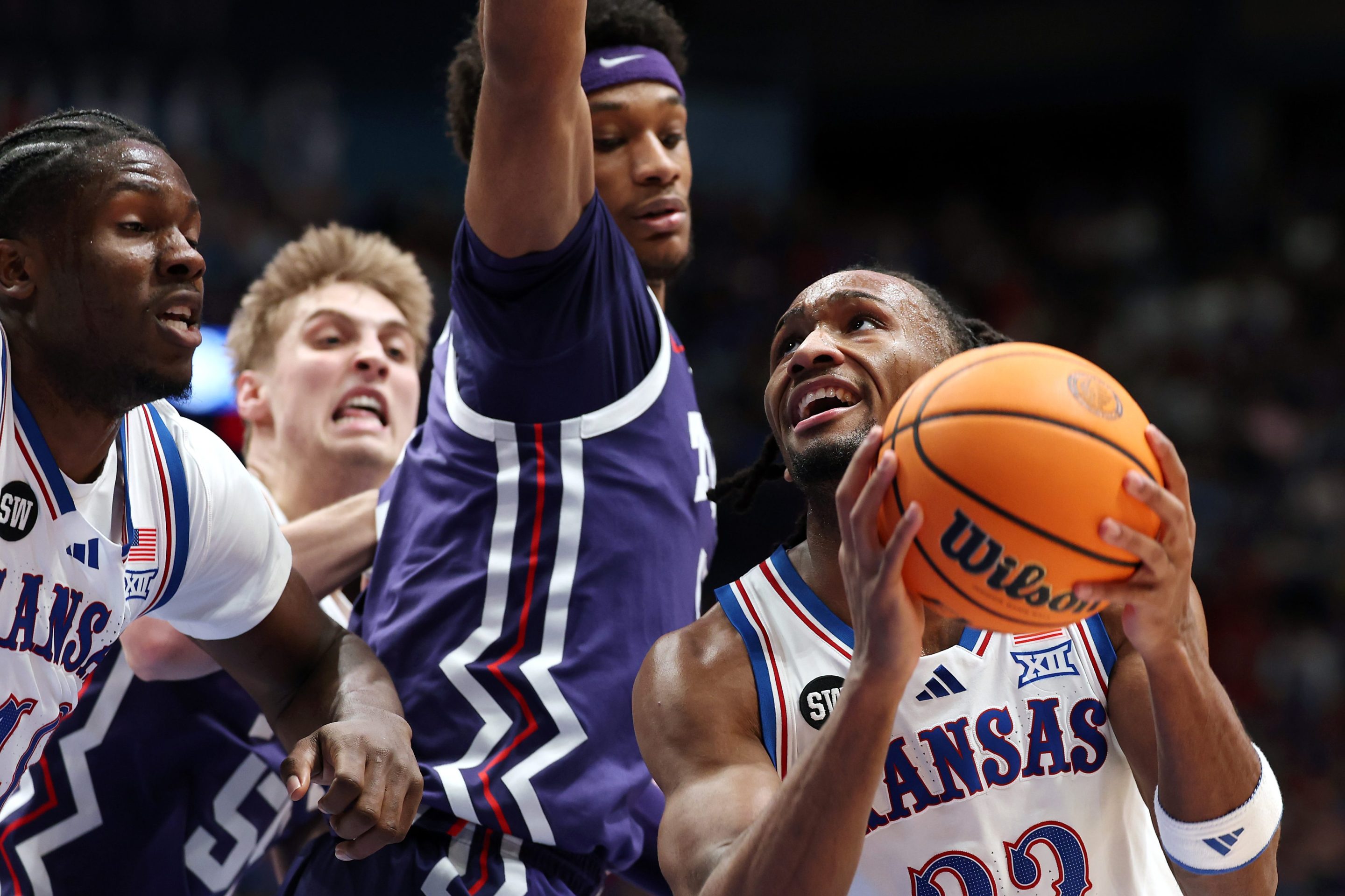 Darryn Peterson #22 of the Kansas Jayhawks looks to shoot as Micah Robinson #5 of the Texas Christian University Horned Frogs defends