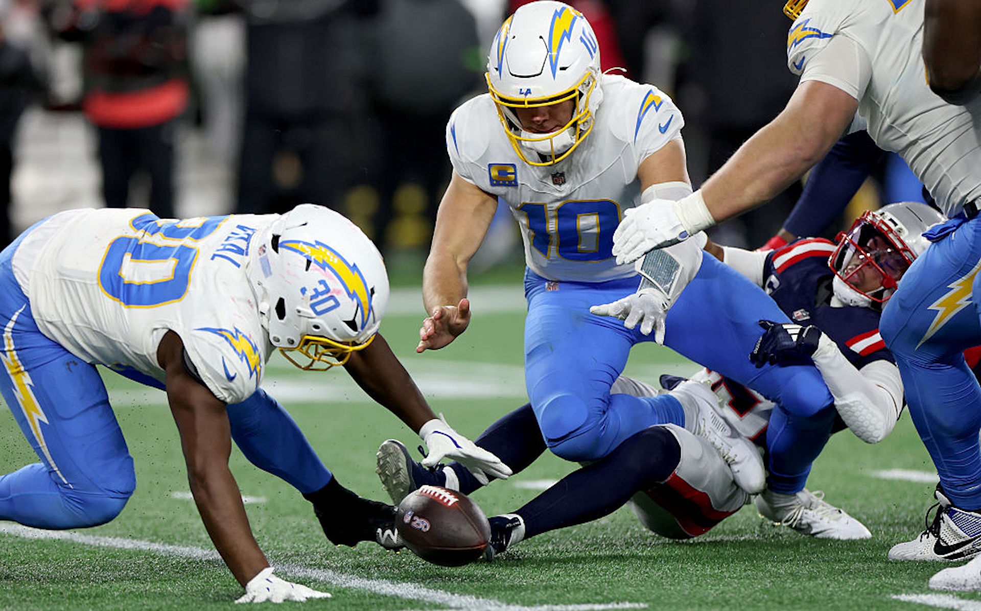 Foxborough, MA January 11, 2026 Los Angeles Chargers running back Kimani Vidal (30) recovers a fumble by Los Angeles Chargers quarterback Justin Herbert (10) in the third quarter during the AFC wild card game between the Los Angeles Chargers and the New England Patriots at the Gillette Stadium in Foxborough, MA on Sunday, January 11, 2026.