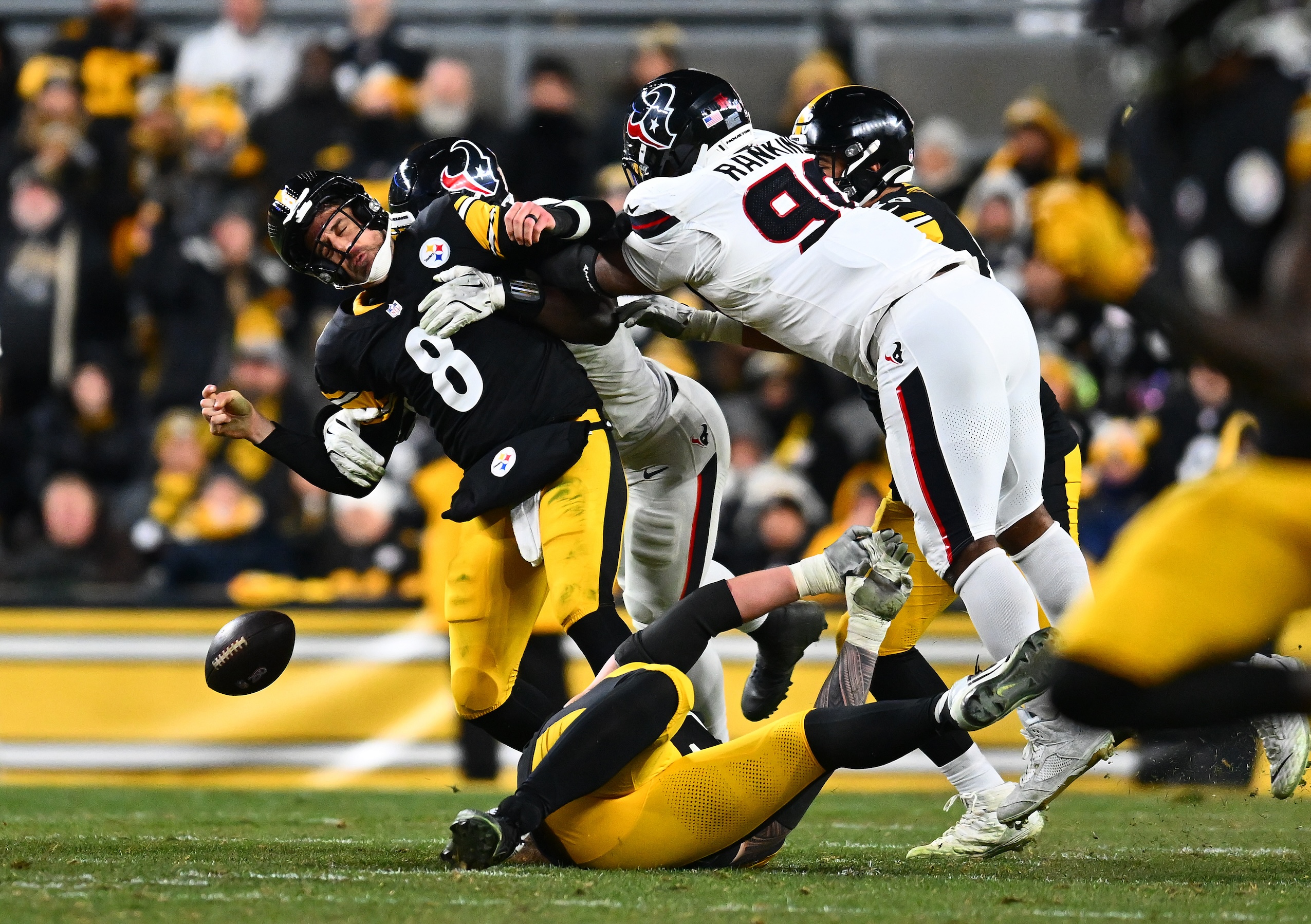 Will Anderson Jr. #51 of the Houston Texans forces Aaron Rodgers #8 of the Pittsburgh Steelers to fumble the ball and Sheldon Rankins #90 of the Houston Texans returns it for a touchdown in the fourth quarter of an NFL wild card playoff game on January 12, 2026.