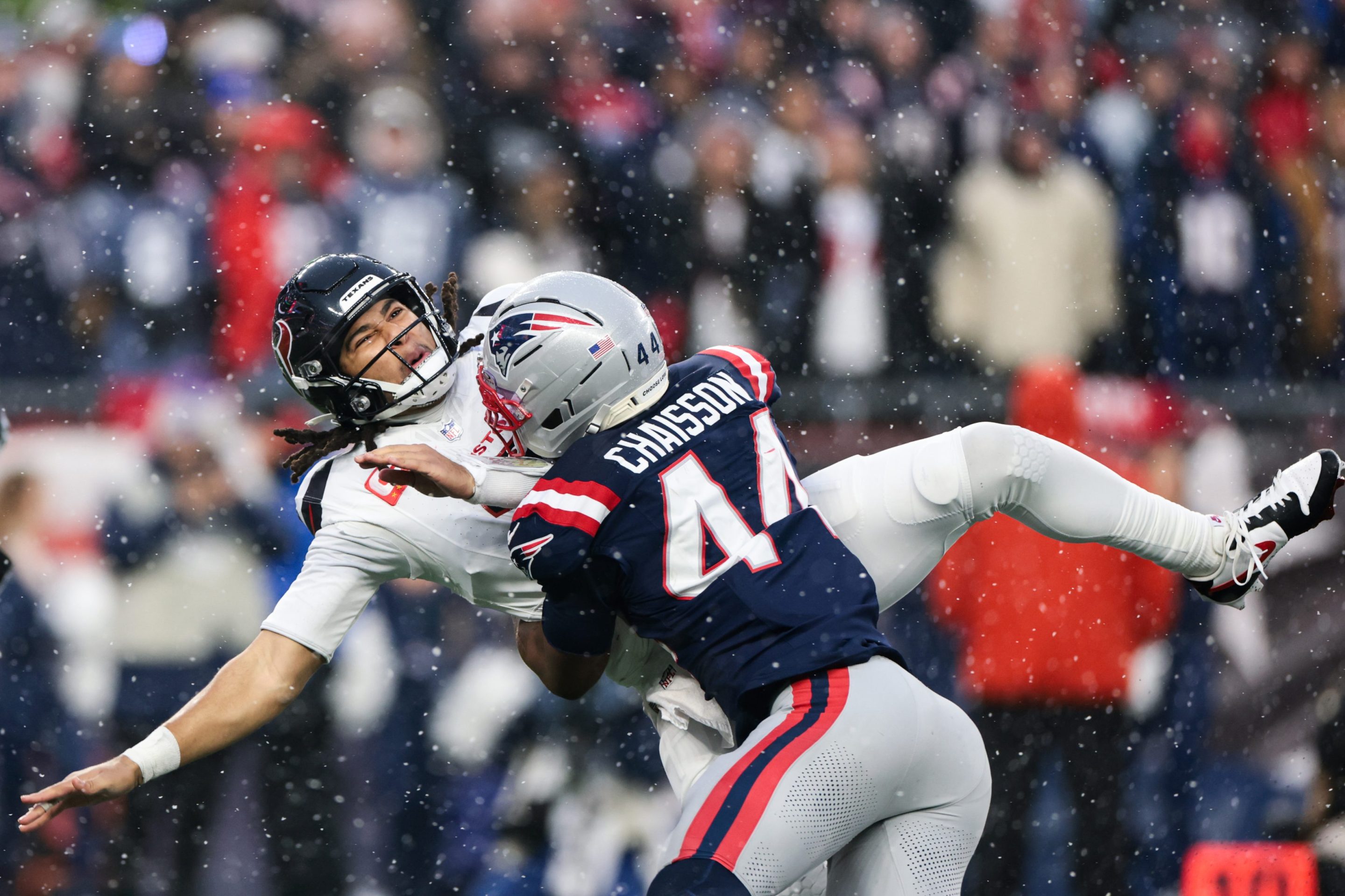 K'lavon Chaisson #44 of the New England Patriots tackles C.J. Stroud #7 of the Houston Texans in the first half during an AFC Divisional Playoff game