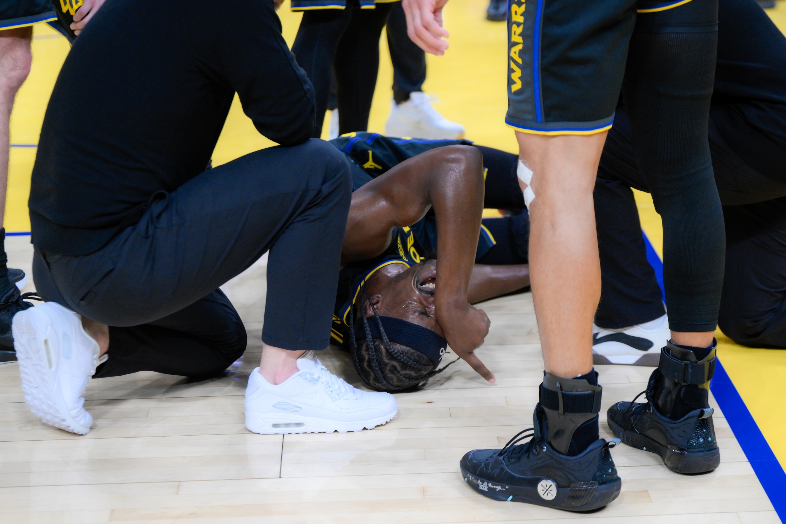 Jimmy Butler on the ground, in pain.