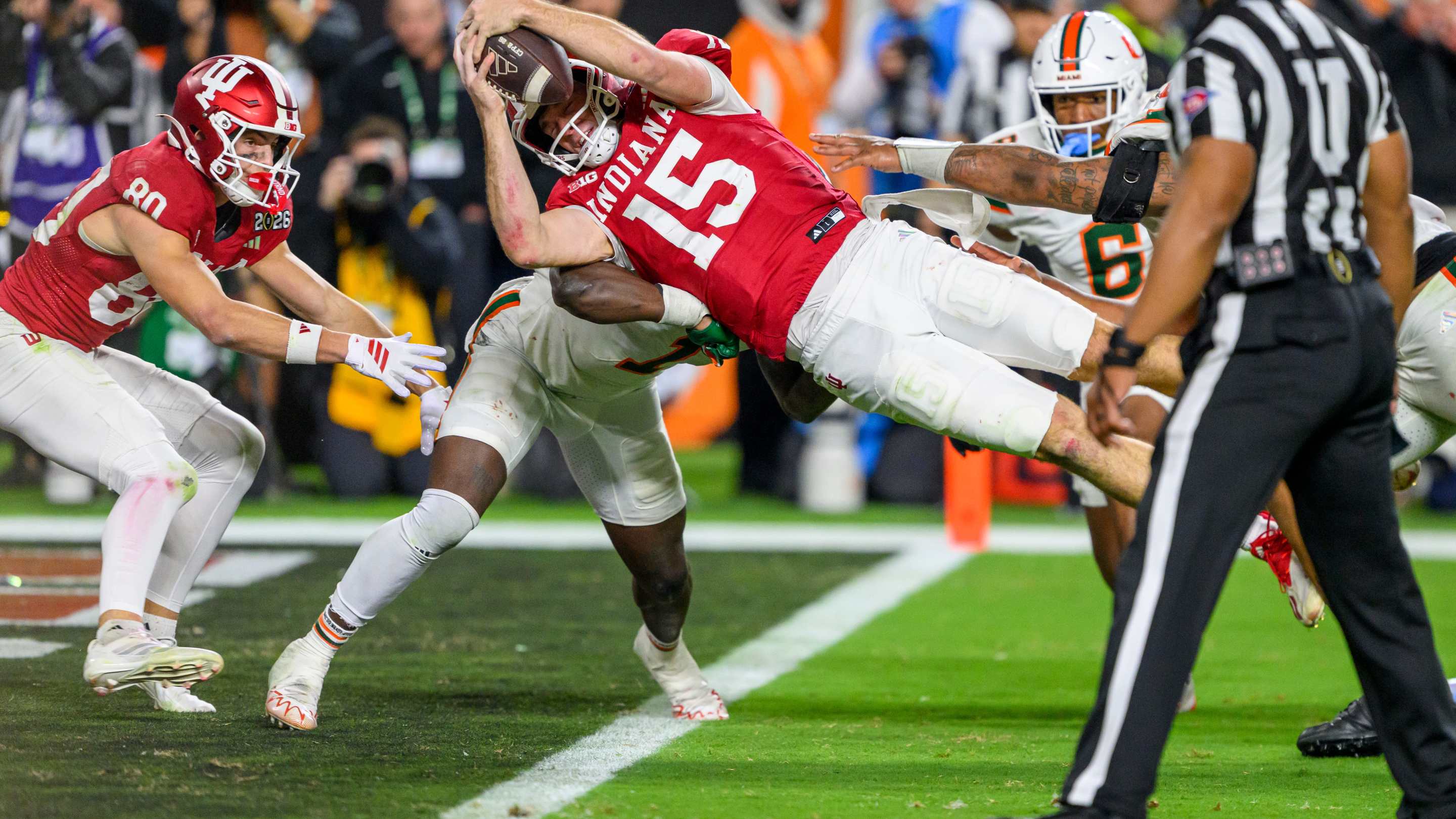 Fernando Mendoza #15 of the Indiana Hoosiers dives into across the goal line to score a touchdown during the Indiana Hoosiers versus the Miami Hurricanes College Football Playoff National Championship Game Presented by AT&T on January 19, 2026, at Hard Rock Stadium in Miami Gardens, FL
