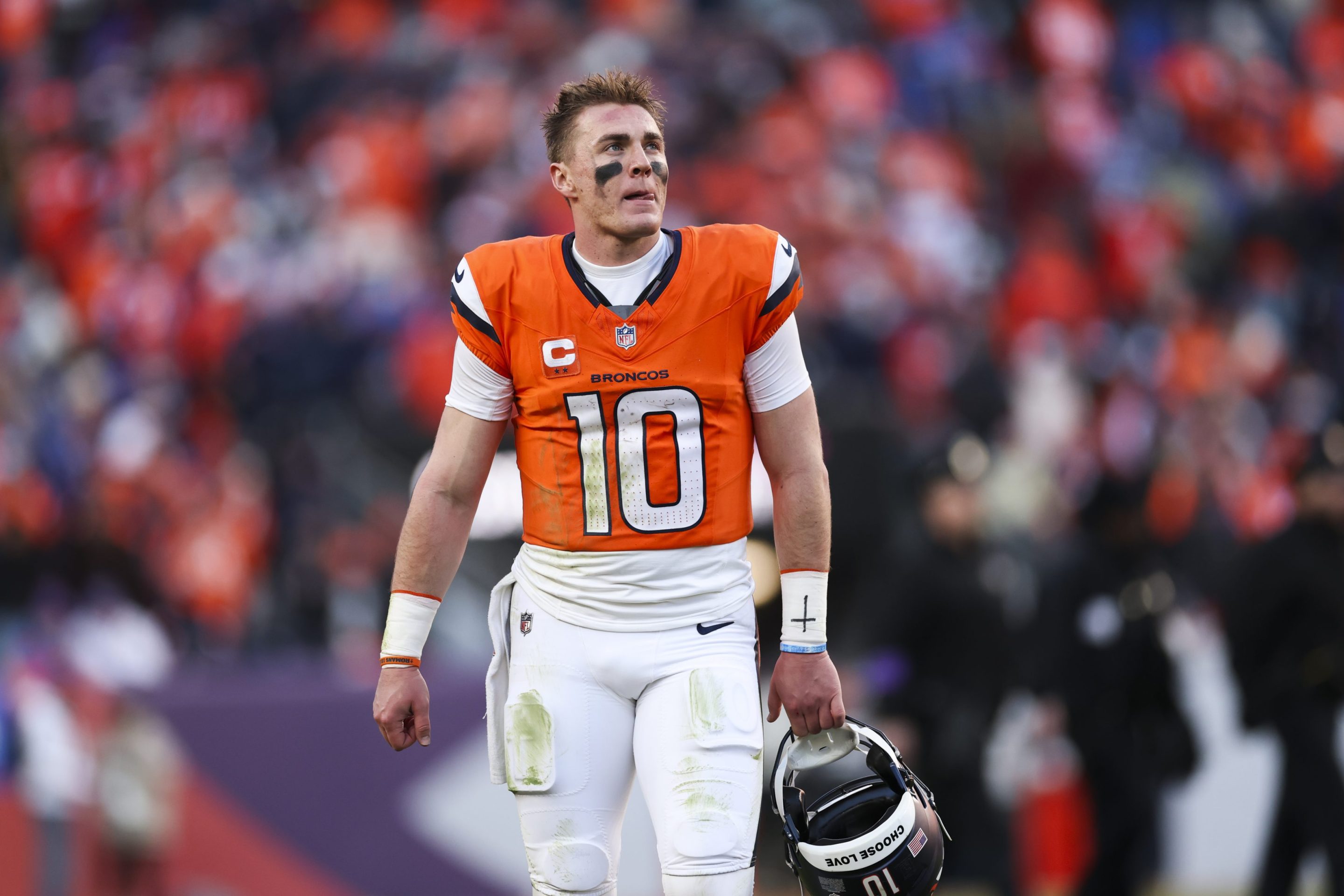 Bo Nix #10 of the Denver Broncos looks on at half-time of the NFL football divisional playoff game against the Buffalo Bills