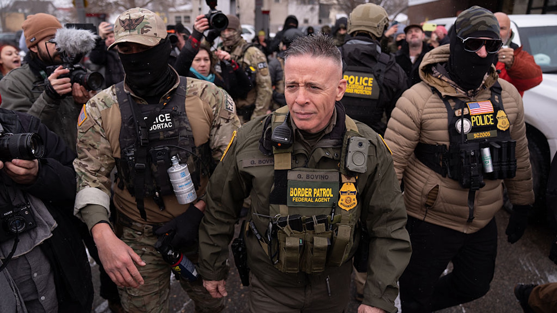 U.S. Customs and Border Protection (CBP) Commissioner Gregory Bovino with his security team while a group of citizens opposed to the country's immigration policies protested him in Minnesota on January 21, 2026.