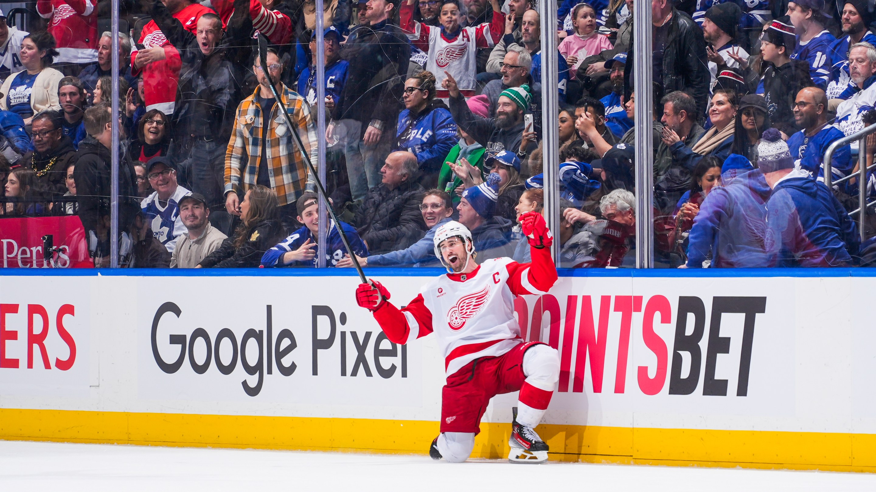 Dylan Larkin #71 of the Detroit Red Wings celebrates scoring an overtime winning goal against the Toronto Maple Leafs