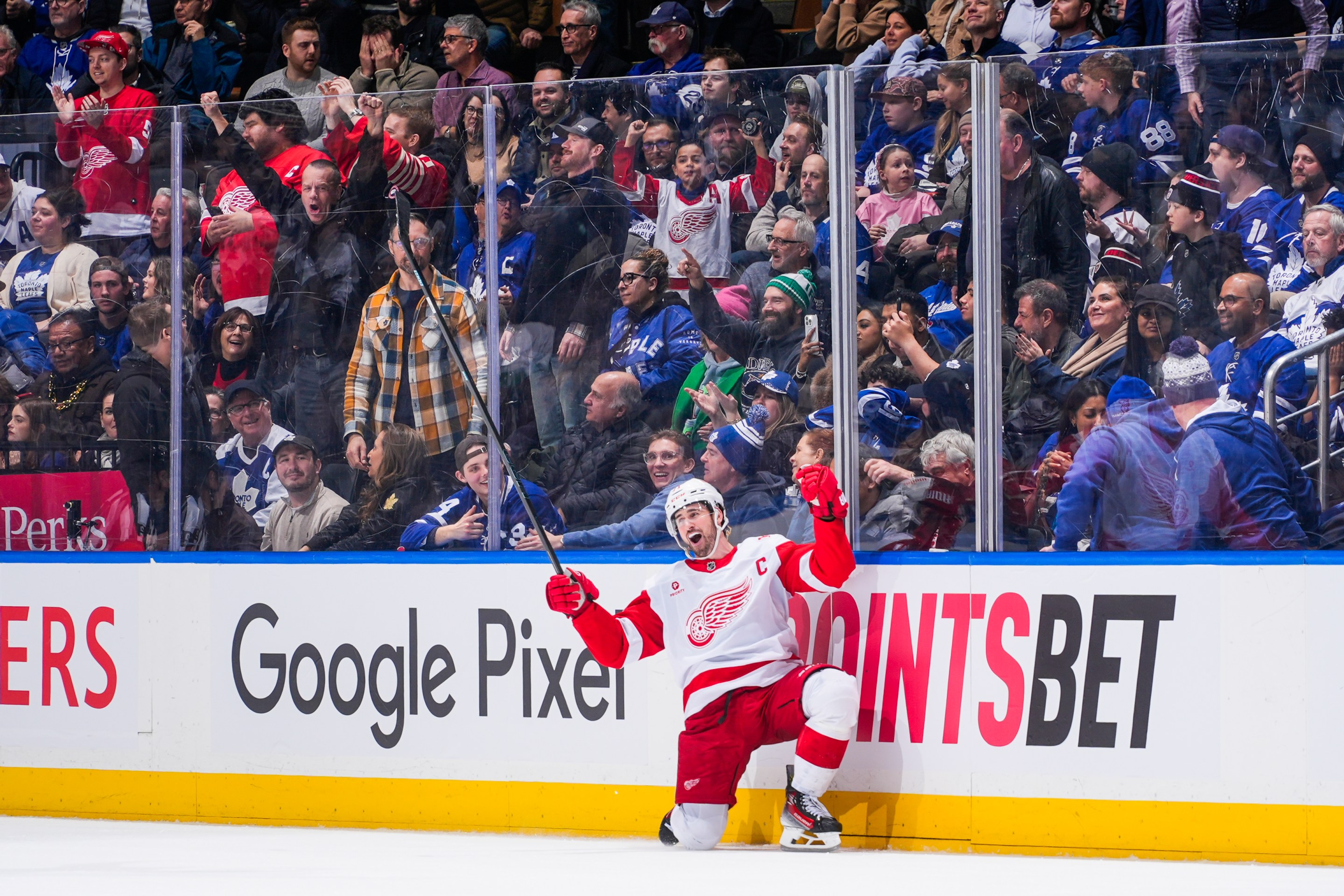 Dylan Larkin #71 of the Detroit Red Wings celebrates scoring an overtime winning goal against the Toronto Maple Leafs