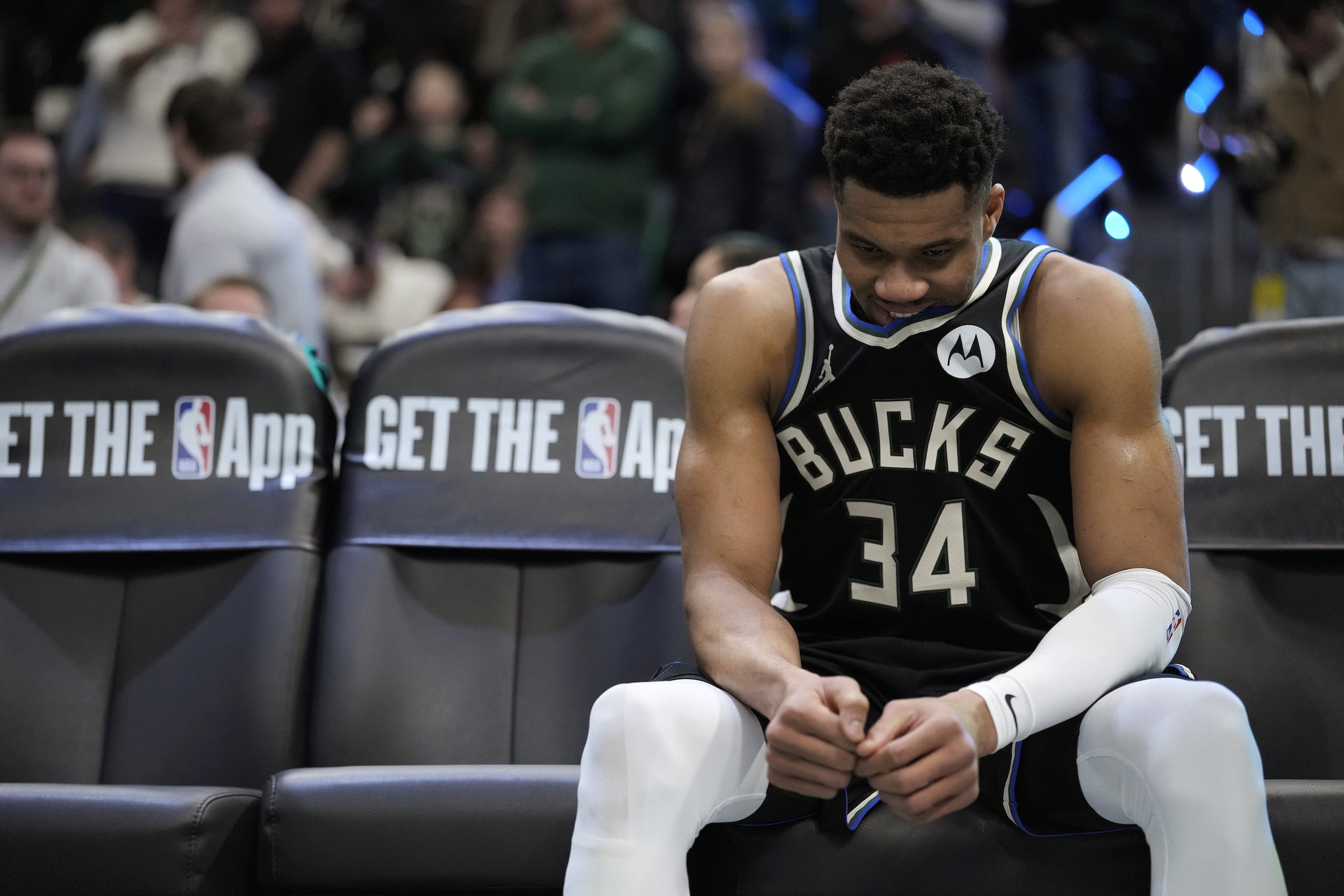 Giannis Antetokounmpo looks bummed on the sideline.