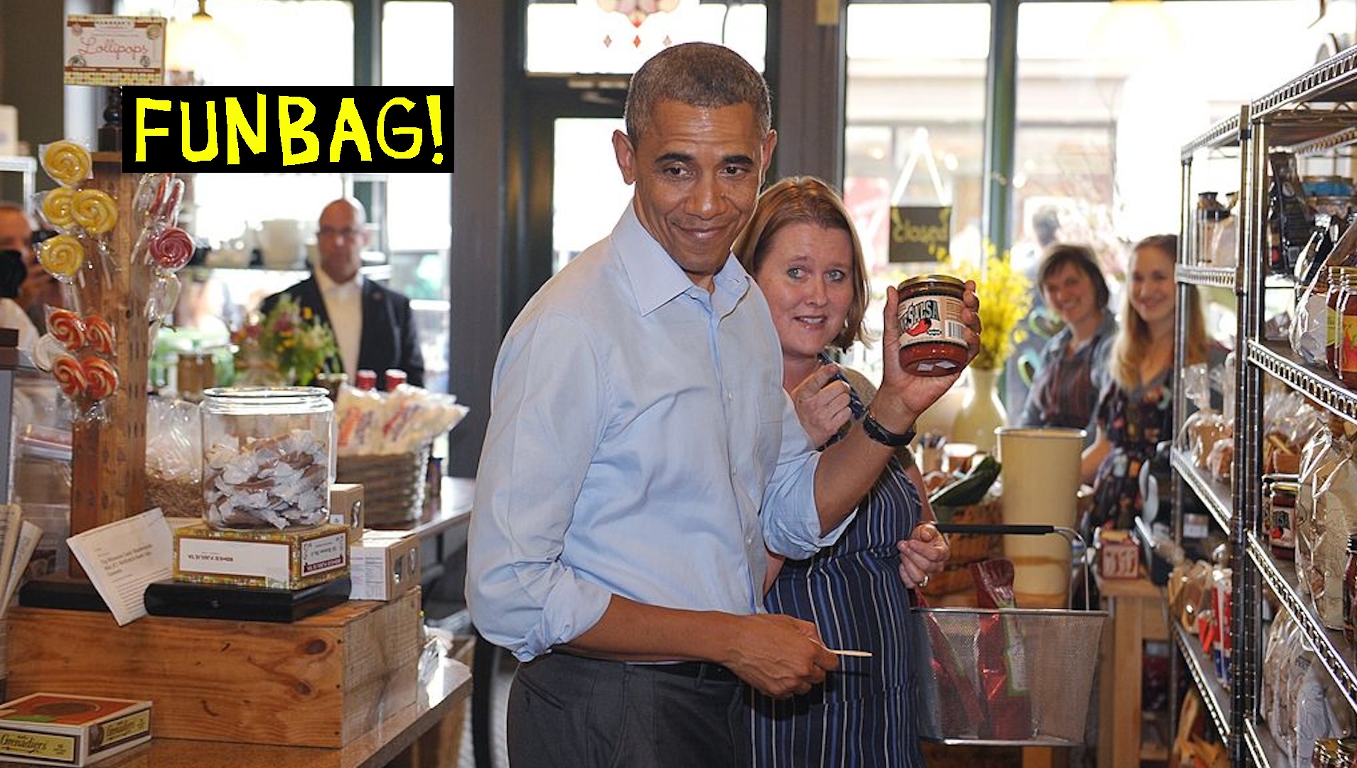 US President Barack Obama holds up a jar of salsa while shopping at the Golden Fig food store in St. Paul, Minnesota on June 26, 2014. The store offers Minnesota produced foods and gifts. AFP PHOTO/Mandel NGAN