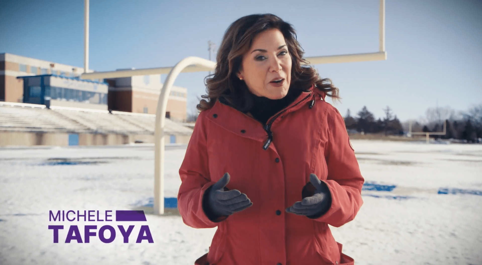 Michele Tafoya on a snowy football field