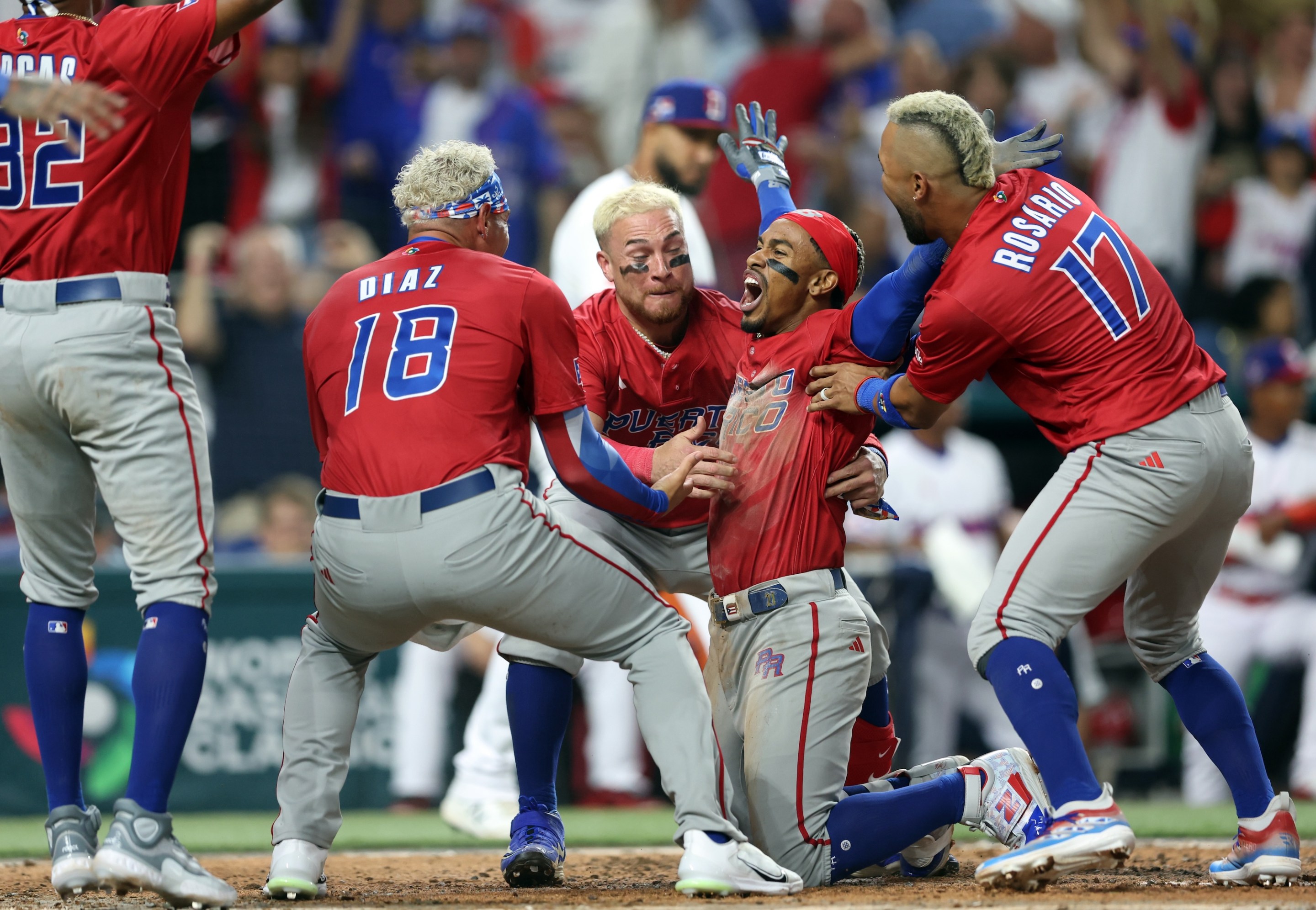 Francisco Lindor #12 of Team Puerto Rico celebrates with teammates after scoring in the fifth inning of Game 10 of Pool D between Team Puerto Rico and Team Dominican Republic at loanDepot Park on Wednesday, March 15, 2023 in Miami, Florida.