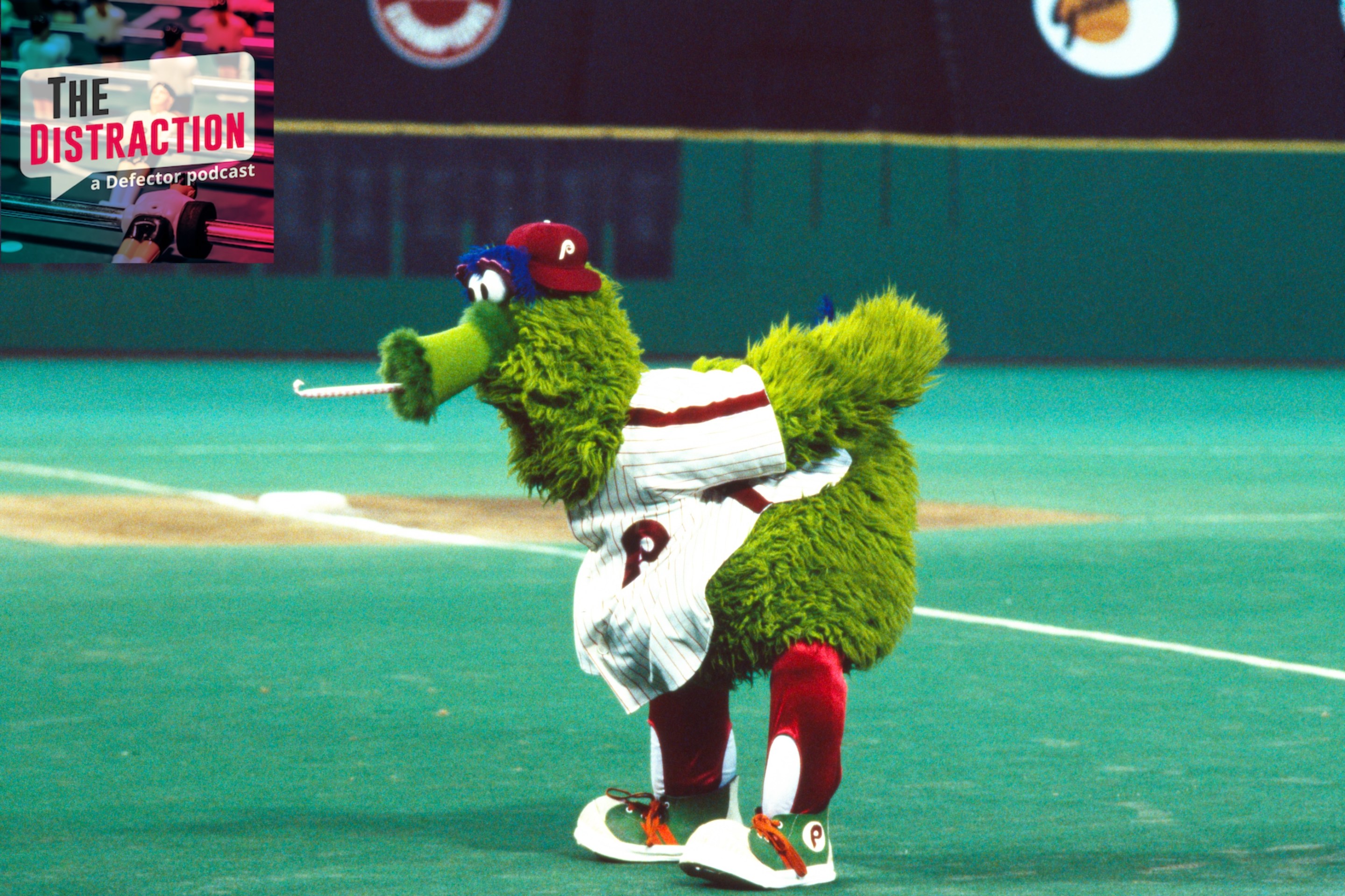 Phillie Phanatic, mascot of the Philadelphia Phillies, pumps up the crowd with some of his signature goofy antics during a game against the Pittsburgh Pirates, August 9-11, 1982, at Veterans Stadium in Philadelphia, Pennsylvania back in 1982. The turf looks crazy. His weird tongue is sticking out.