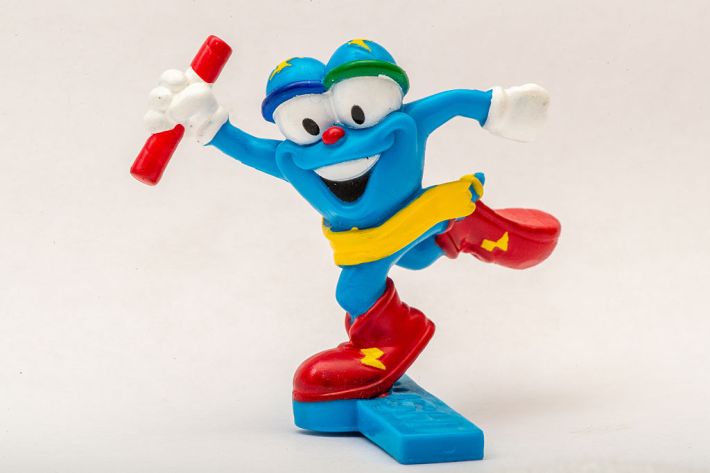 A detail view of a plastic figurine of 1996 Atlanta Olympics mascot Izzy holding a running relay baton. (Photo by Erica Denhoff/Icon Sportswire via Getty Images)