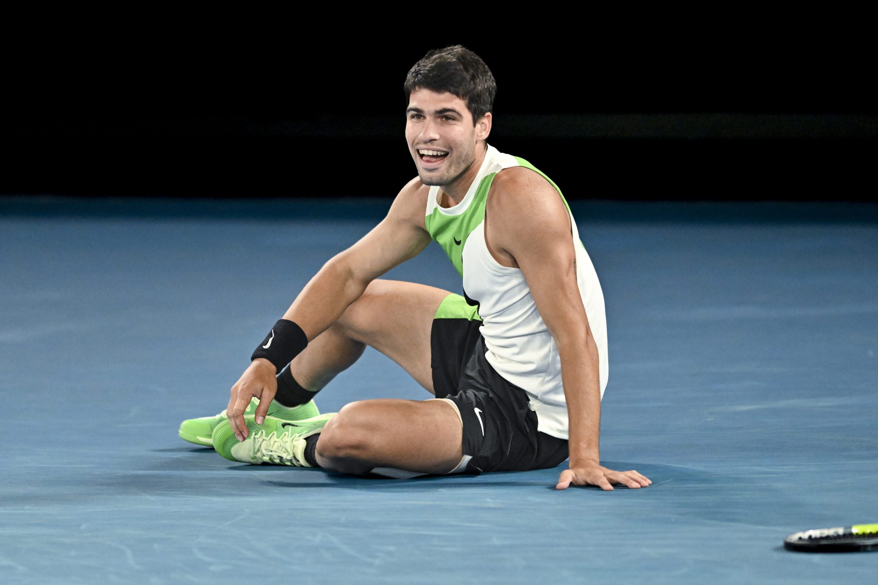 Carlos Alcaraz celebrates on the court after winning the Australian Open.