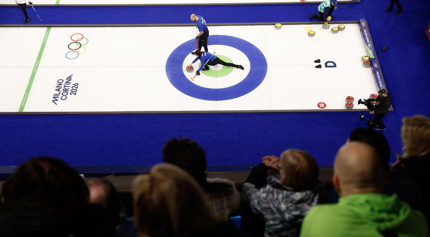 Italy's Stefania Constantini and Italy's Amos Mosaner compete in the curling mixed doubles round robin semi-final between USA and Italy during the Milano Cortina 2026 Winter Olympic Games at the Cortina Curling Olympic Stadium in Cortina d’Ampezzo on February 9, 2026.