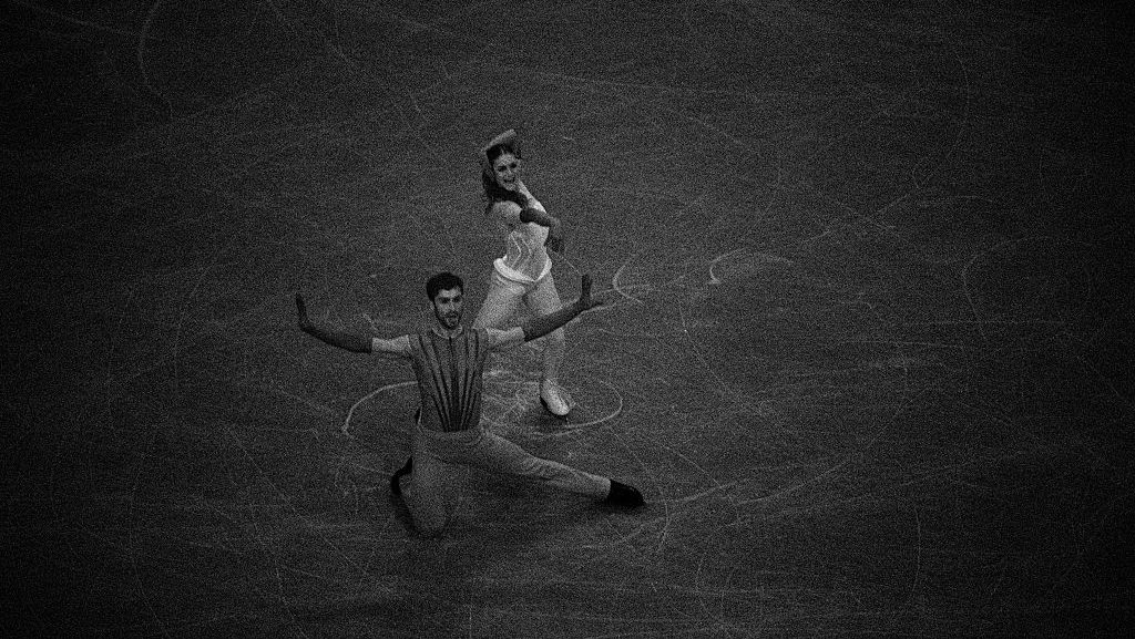 A black and white photo of Laurence Fournier Beaudry and partner Guillaume Cizeron of Team France competing in the Ice Dance - Rhythm Dance on day zero of the Milano Cortina 2026 Winter Olympic games at Milano Ice Skating Arena on February 06, 2026 in Milan, Italy.