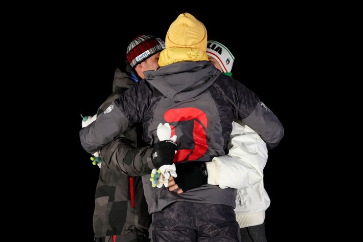 Gold medalist Max Langenhan (C) of Team Germany, Silver medalist Jonas Mueller (L) of Team Austria and Bronze medalist Dominik Fischnaller (R) of Team Italy embrace on the podium during the medal ceremony for the luge men's singles