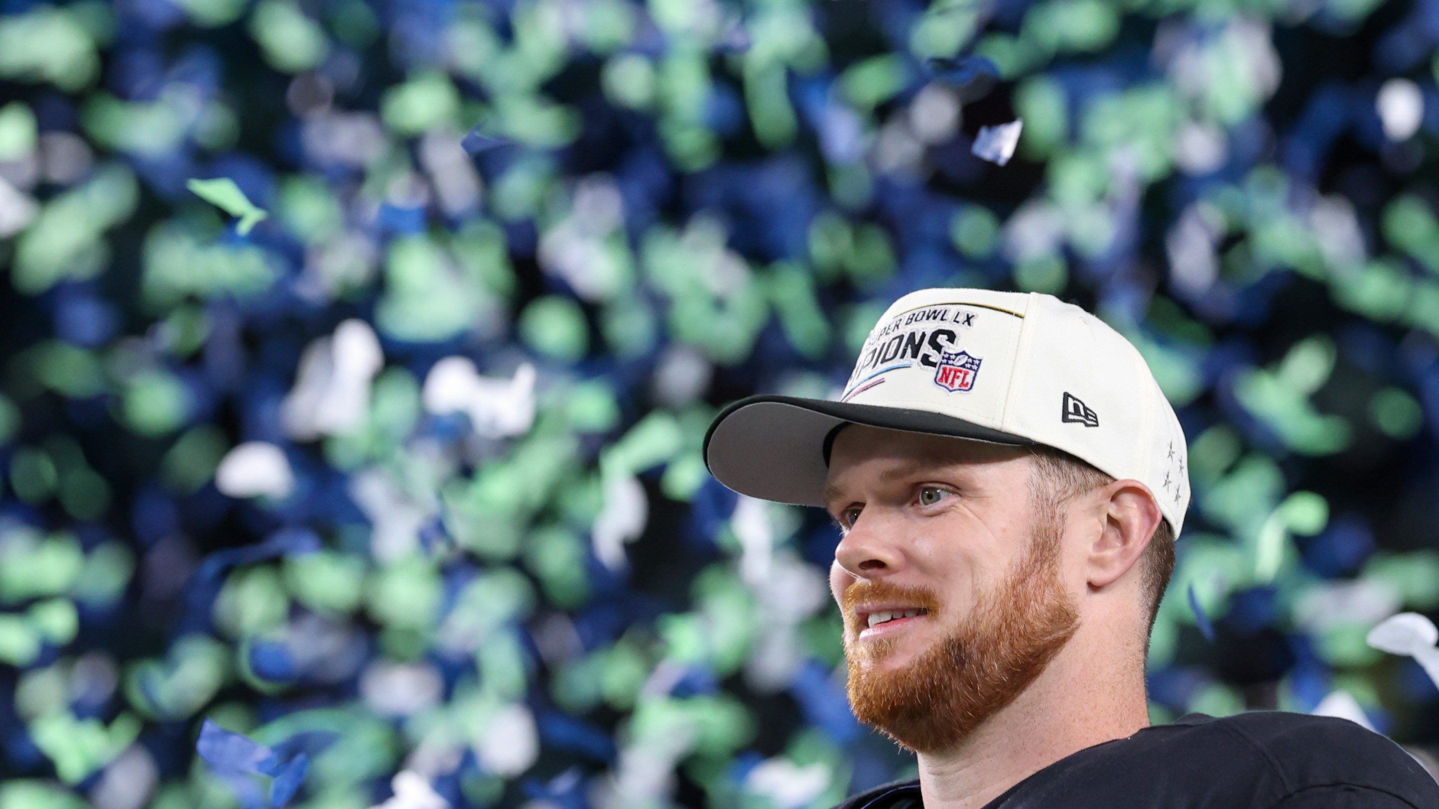 Sam Darnold of the Seattle Seahawks reacts after defeating the New England Patriots 29-13 to win Super Bowl LX. He is kind of making "the Sam Darnold Face" while confetti falls behind him.