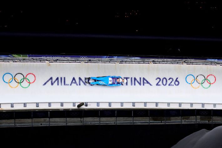 the italian mens doubles luge team going real fast down the ice tube