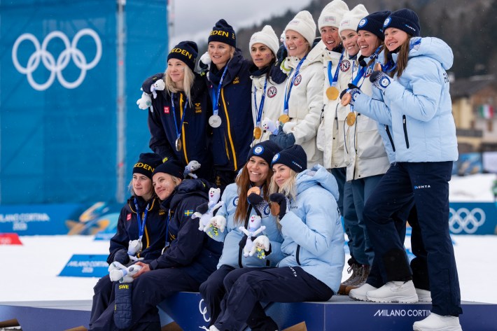 Silver medallists Sweden's Jonna Sundling, Sweden's Frida Karlsson, Sweden's Ebba Andersson and Sweden's Linn Svahn, gold medallists Norway's Heidi Weng, Norway's Karoline Simpson-Larsen, Norway's Astrid Oeyre Slind and Norway's Kristin Austgulen Fosnaes, and Bronze medallists Finland's Jasmi Joensuu, Finland's Vilma Ryytty, Finland's Kerttu Niskanen and Finland's Johanna Matintalo celebrate on the podium for the cross-country women's 4 x 7,5km relay event of the Milano Cortina 2026 Winter Olympic Games