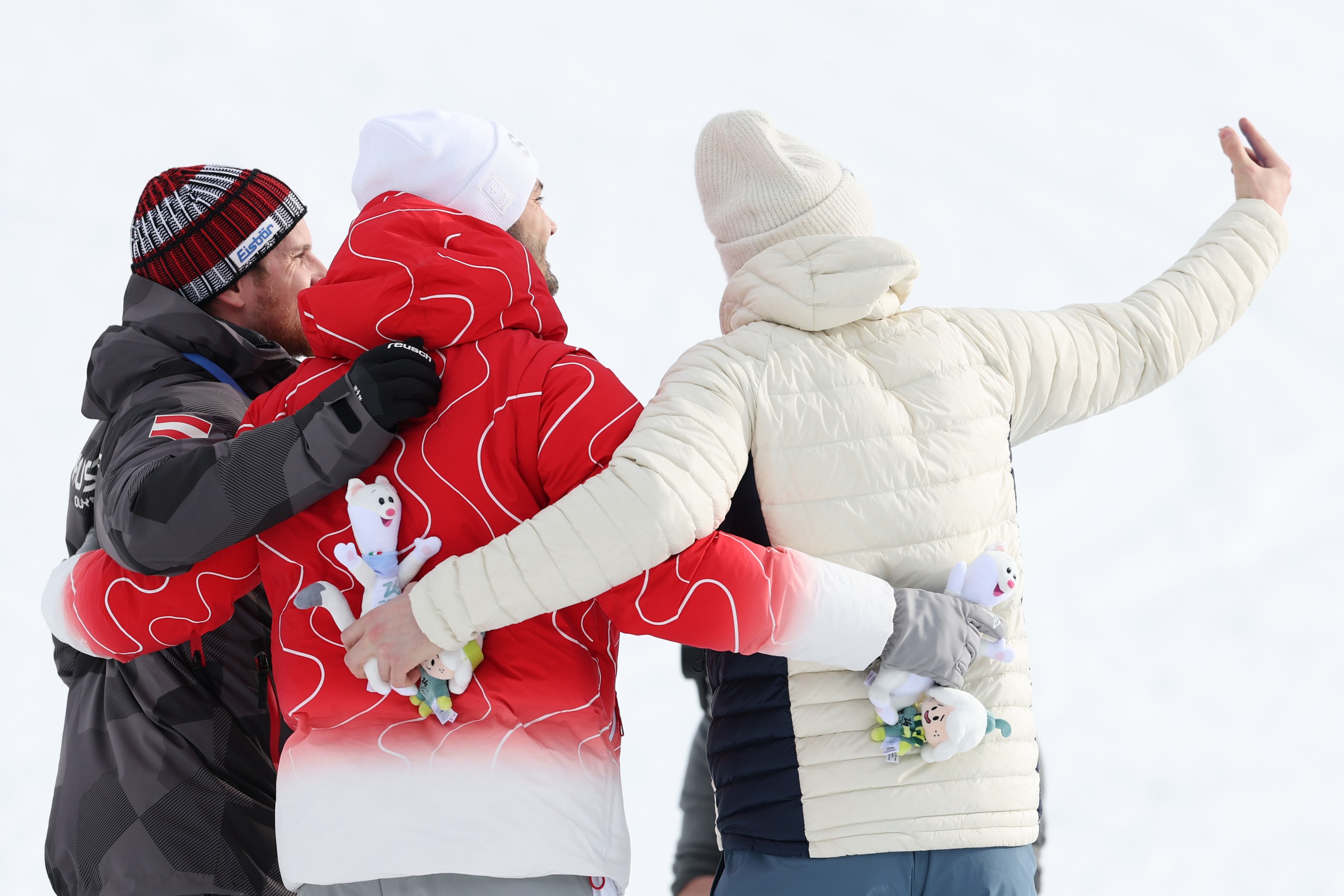 Gold medalist Loic Meillard of Team Switzerland, Silver medalist Fabio Gstrein of Team Austria and Bronze medalist Henrik Kristoffersen of Team Norway celebrate by taking a victory selfie on the podium during the medal ceremony for the Men's Slalom Run