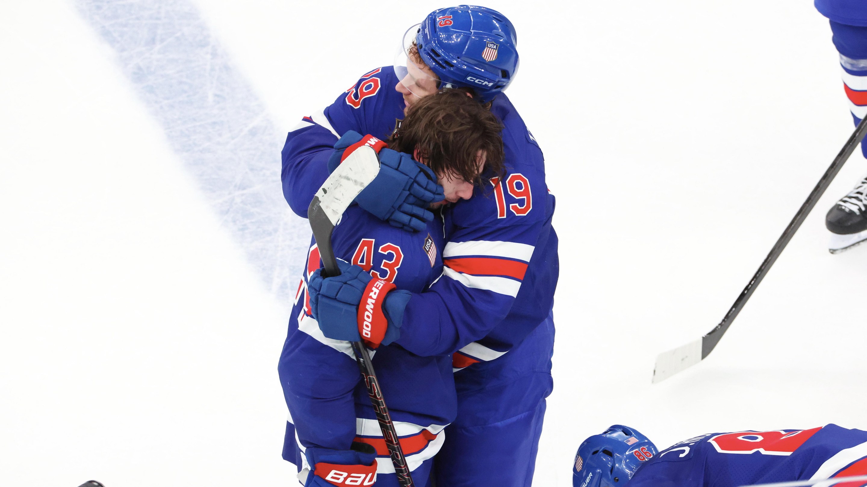 MILAN, ITALY - FEBRUARY 18: Quinn Hughes #43 of Team United States celebrate his victory goal in overtime with Matthew Tkachuk #19 and Jack Hughes #86 during the Ice Hockey Men's Play-off Quarterfinals match between Team United States and Team Sweden on day twelve of the Milano Cortina 2026 Winter Olympic games at Milano Santagiulia Ice Hockey Arena on February 18, 2026 in Milan, Italy. (Photo by Xavier Laine/Getty Images)