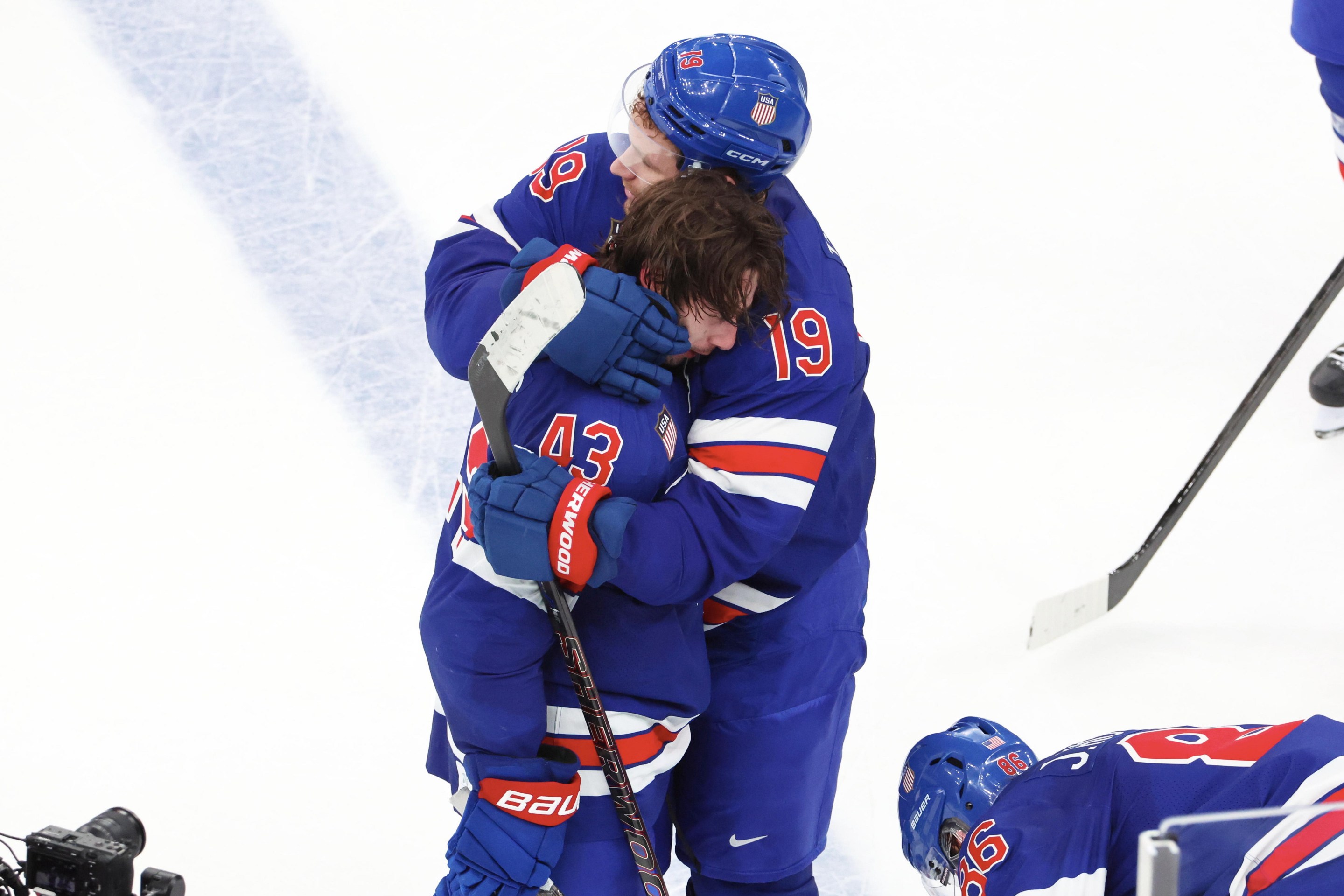 MILAN, ITALY - FEBRUARY 18: Quinn Hughes #43 of Team United States celebrate his victory goal in overtime with Matthew Tkachuk #19 and Jack Hughes #86 during the Ice Hockey Men's Play-off Quarterfinals match between Team United States and Team Sweden on day twelve of the Milano Cortina 2026 Winter Olympic games at Milano Santagiulia Ice Hockey Arena on February 18, 2026 in Milan, Italy. (Photo by Xavier Laine/Getty Images)