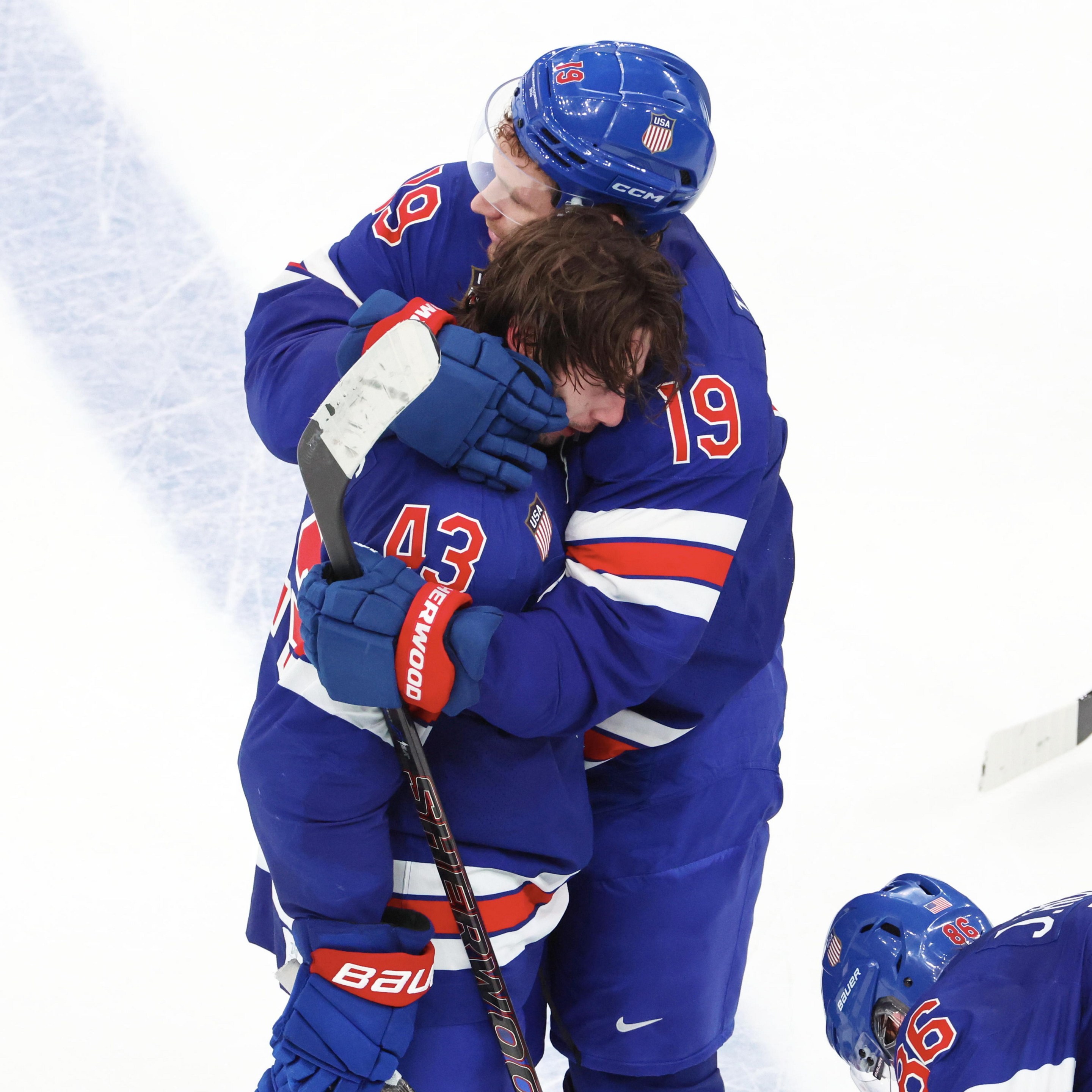 MILAN, ITALY - FEBRUARY 18: Quinn Hughes #43 of Team United States celebrate his victory goal in overtime with Matthew Tkachuk #19 and Jack Hughes #86 during the Ice Hockey Men's Play-off Quarterfinals match between Team United States and Team Sweden on day twelve of the Milano Cortina 2026 Winter Olympic games at Milano Santagiulia Ice Hockey Arena on February 18, 2026 in Milan, Italy. (Photo by Xavier Laine/Getty Images)