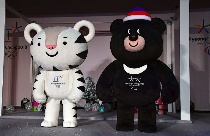 Mascots for South Korea's 2018 Pyeongchang Winter Olympics, a white tiger named "Soohorang" (L) and an Asiatic black bear named "Bandabi" (R), stand on a stage during the mascots' first public staging event at Hoenggye elementary school in Pyeongchang