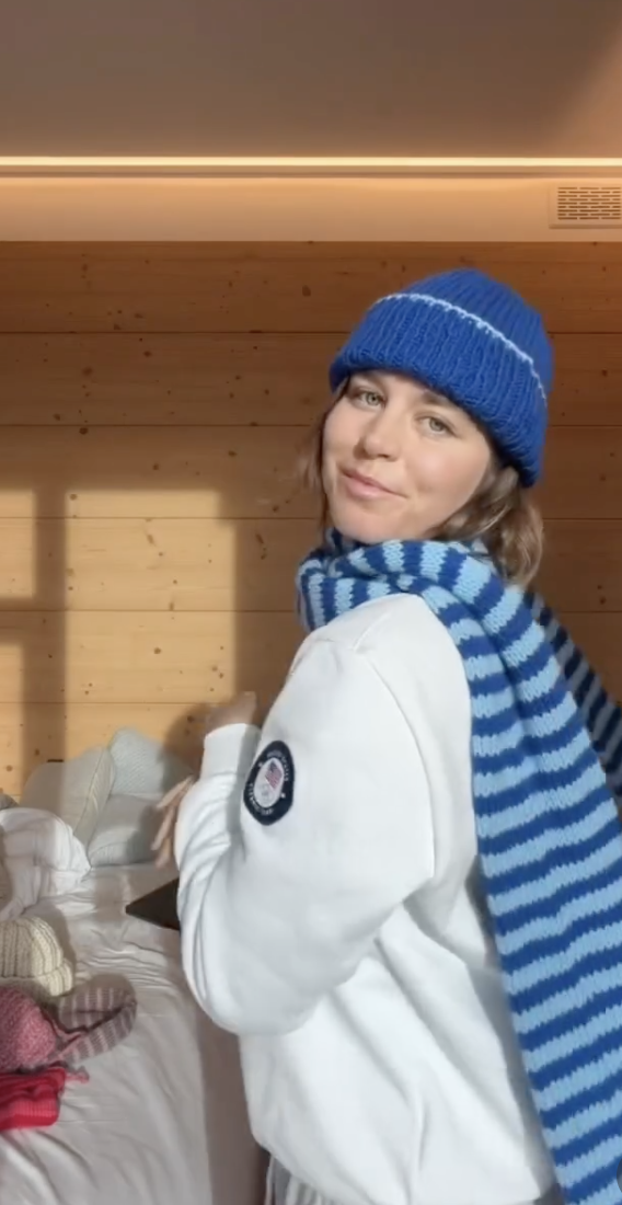 Maddie Mastro modeling a blue homemade beanie and a blue striped scarf on Instagram.
