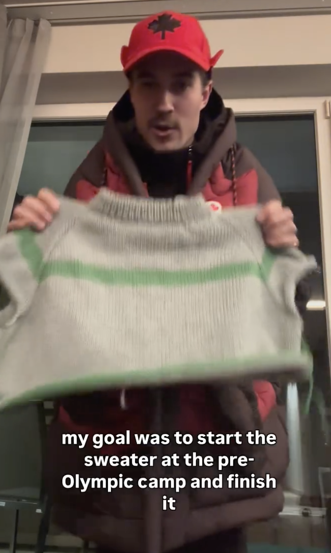 Runnalls holding up the part of a sweater that he'd knitted before the Olympics opening ceremony, taken from his Instagram account. The text reads "my goal was to start the sweater at the pre-Olympic camp and finish it."