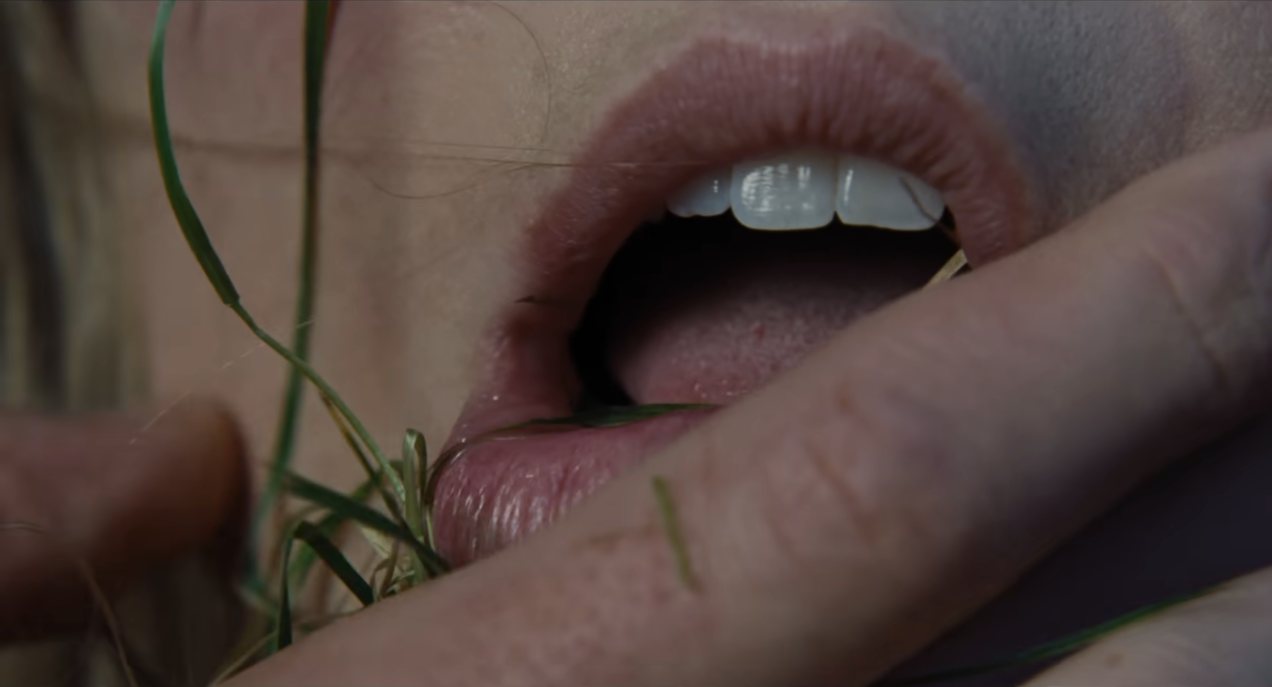 Margot Robbie's mouth, with a hand over it.