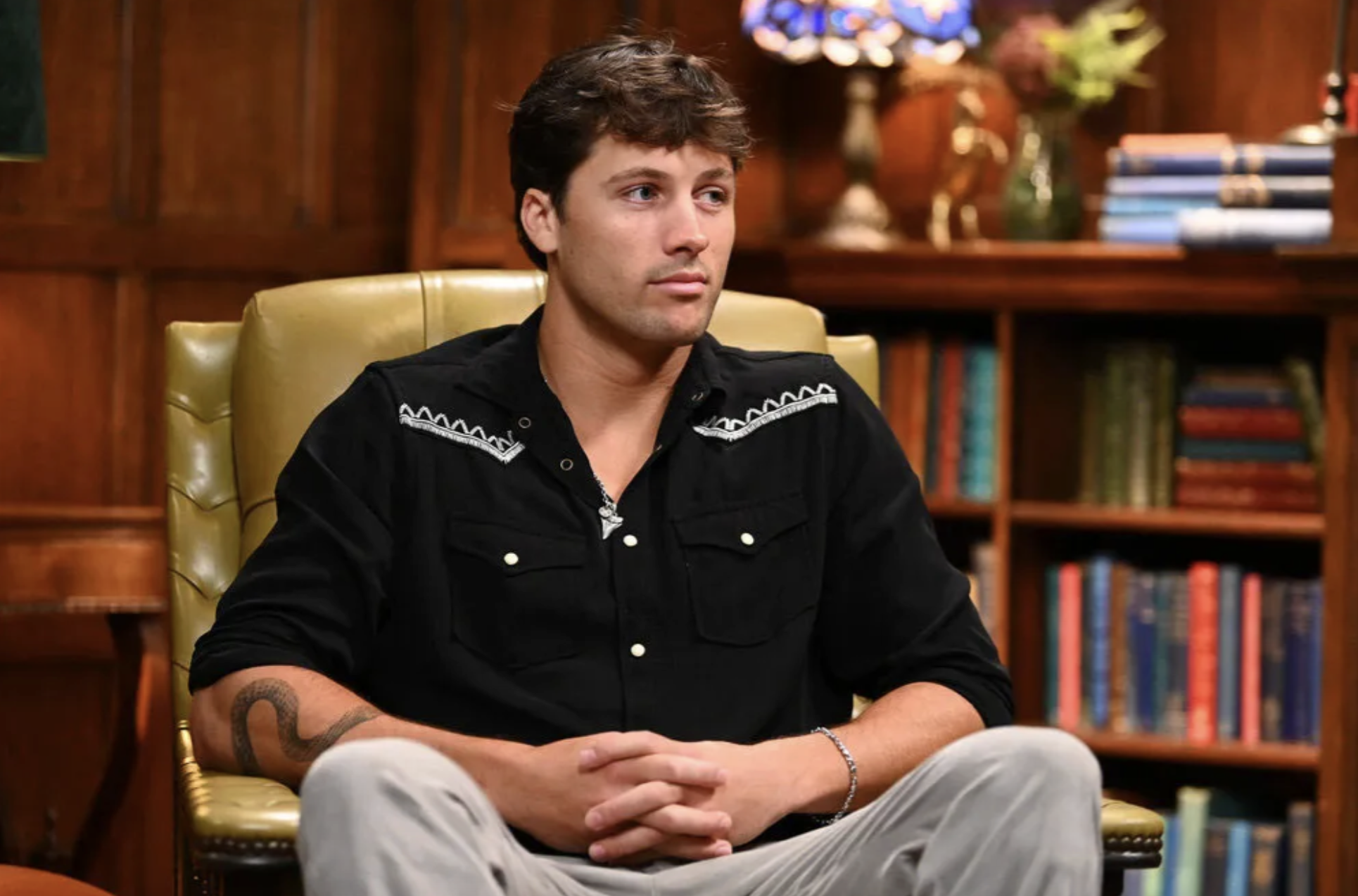 Rob Rausch in a western shirt sitting in a chair