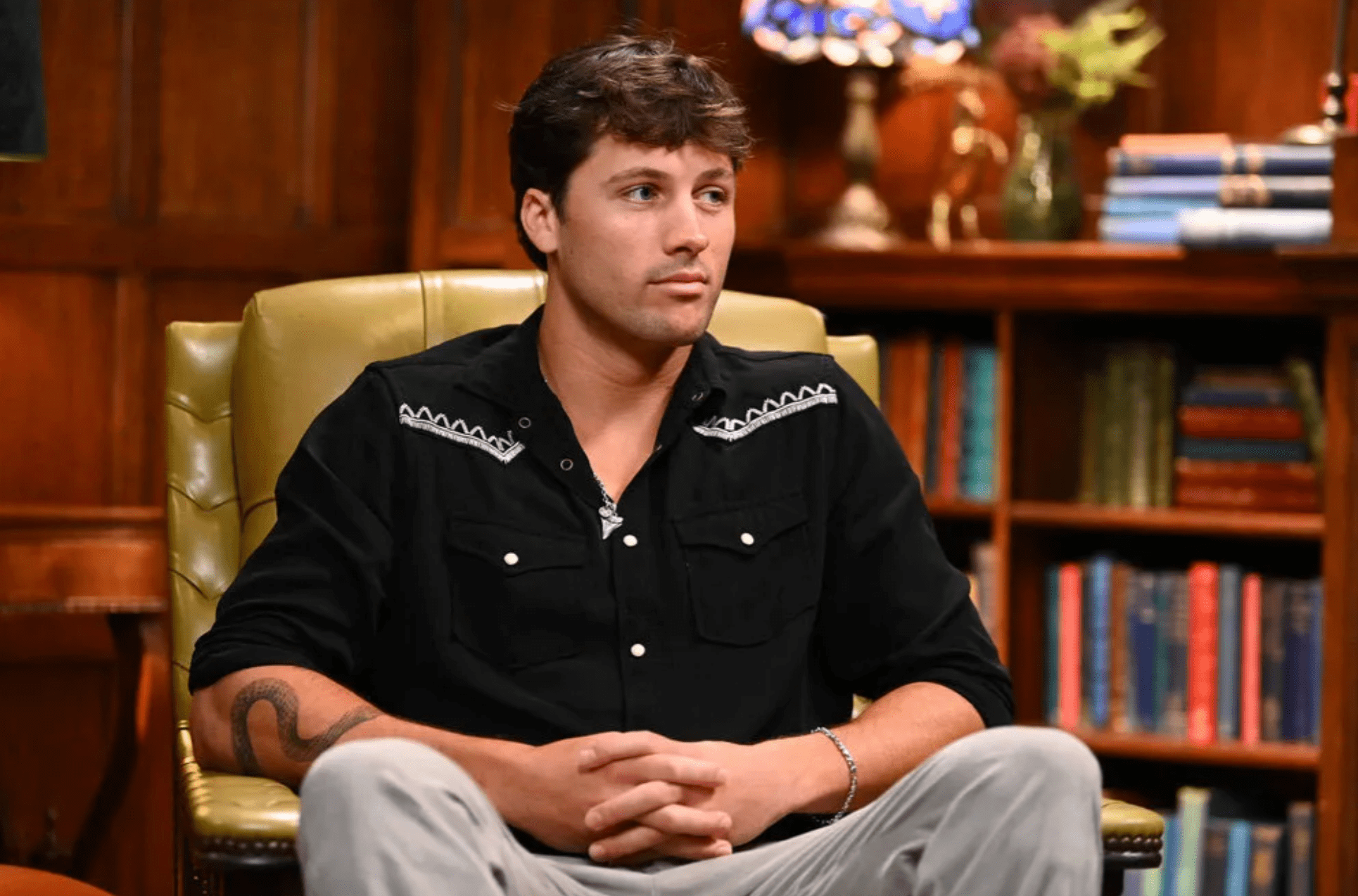 Rob Rausch in a western shirt sitting in a chair