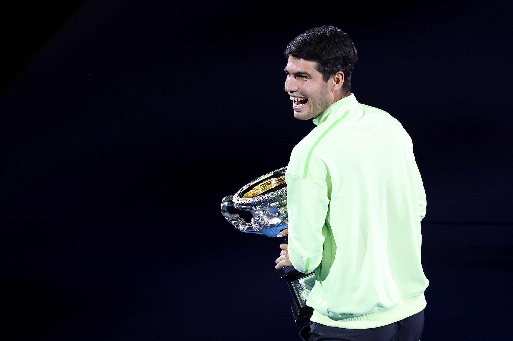 Carlos Alcaraz of Spain acknowledges fans with the Norman Brookes Challenge Cup after the presentation ceremony following the Men's Singles Final against Novak Djokovic of Serbia during day 15 of the 2026 Australian Open at Melbourne Park on February 01, 2026 in Melbourne, Australia. (Photo by Kelly Defina/Getty Images)