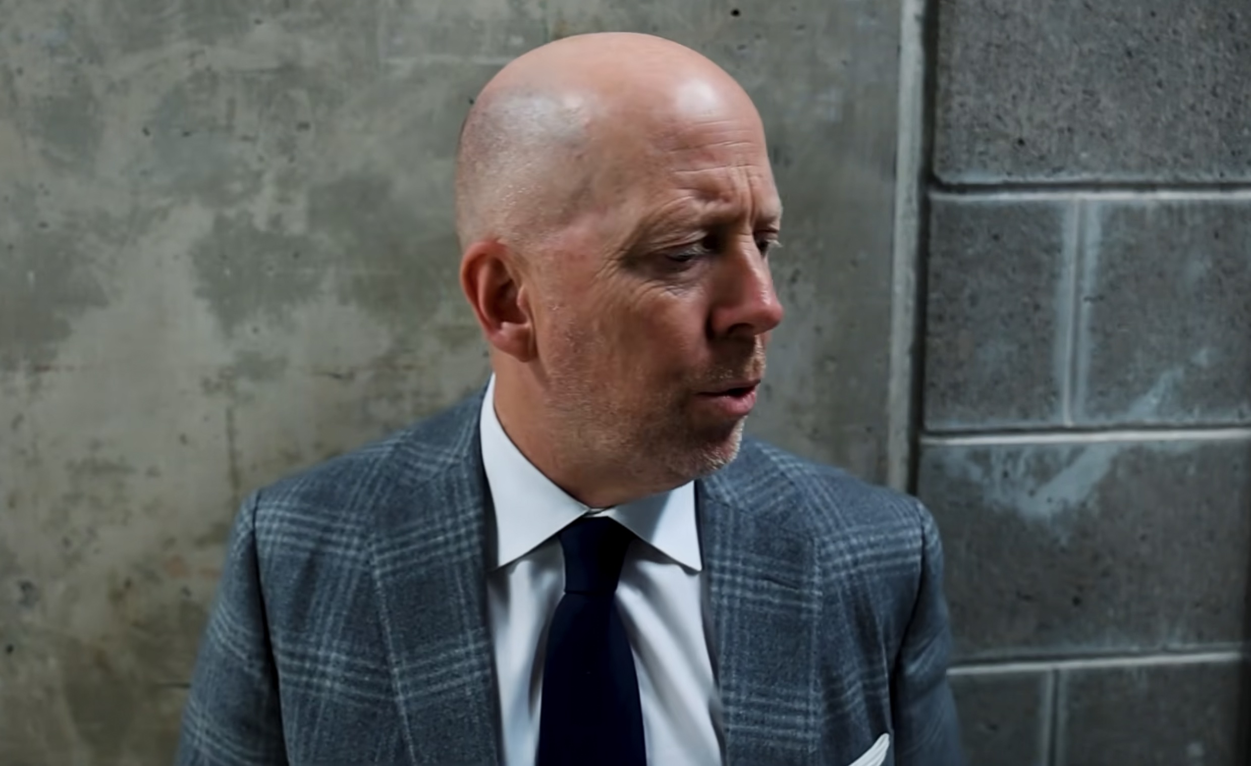 UCLA men's basketball coach Mick Cronin in a postgame scrum after UCLA's blowout loss to Michigan State on Feb. 17