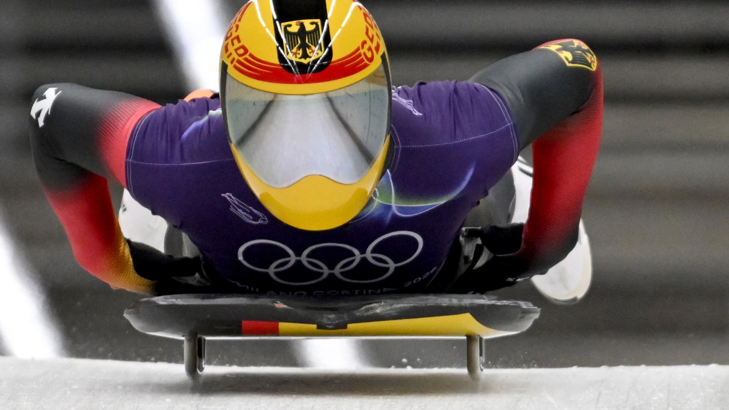 Axel Jungk with the German team's yellow, red, and black helmet, with a reflective visor.