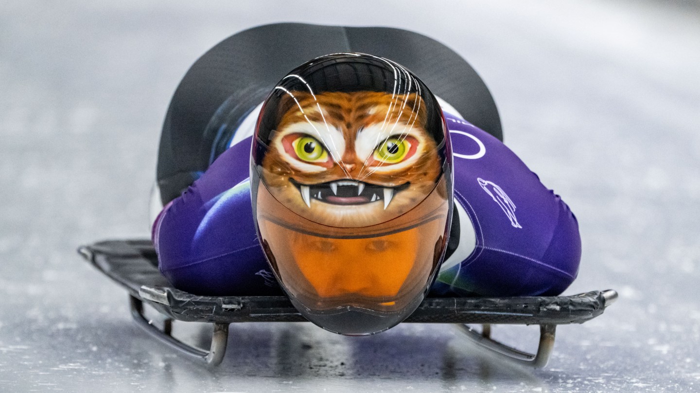 Sujung Hong wears an orange helmet featuring a traditional Korean cat design.