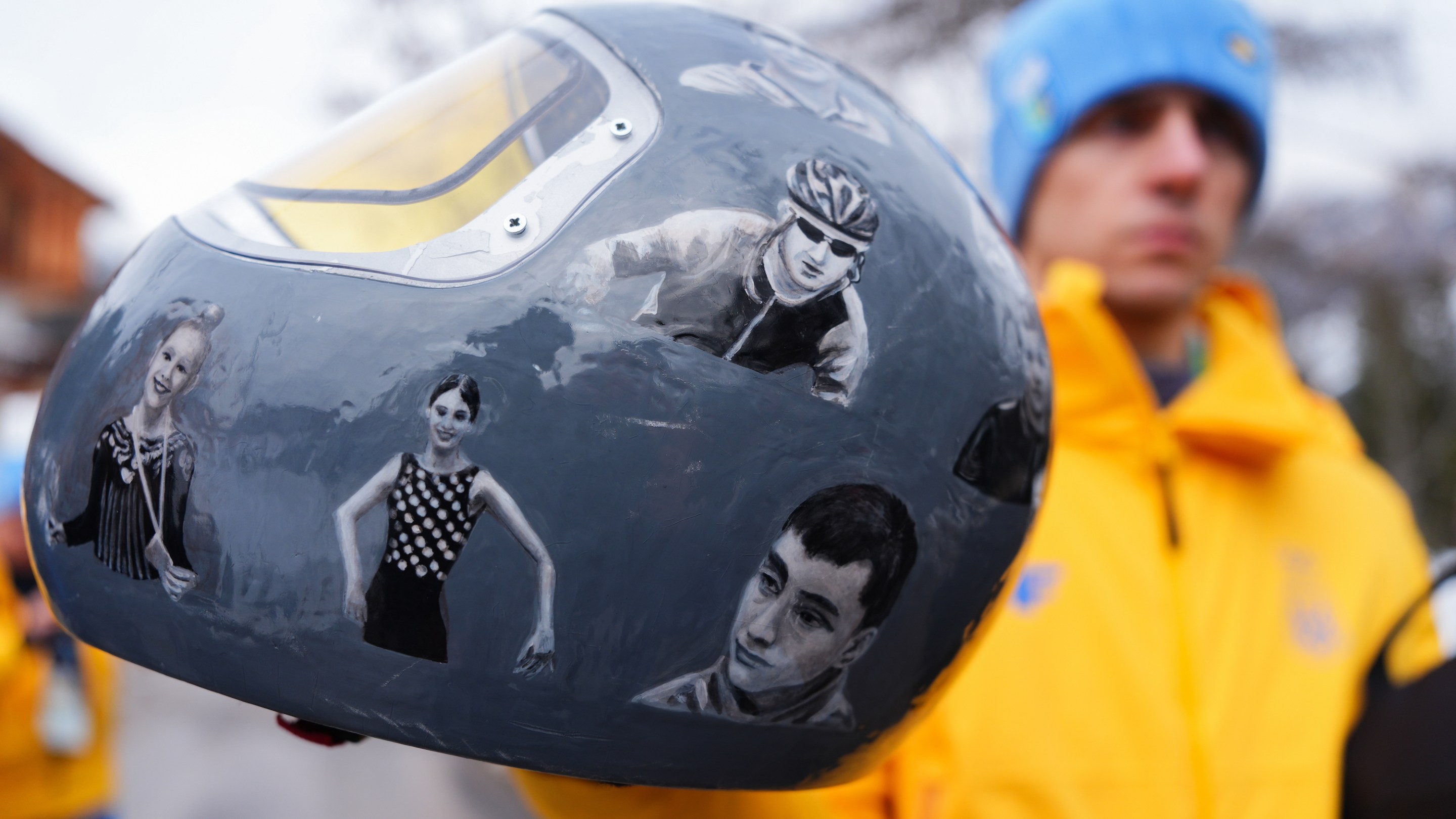 Ukraine's Vladyslav Heraskevych, with his helmet, which features pictures of people killed in the war with Russia.