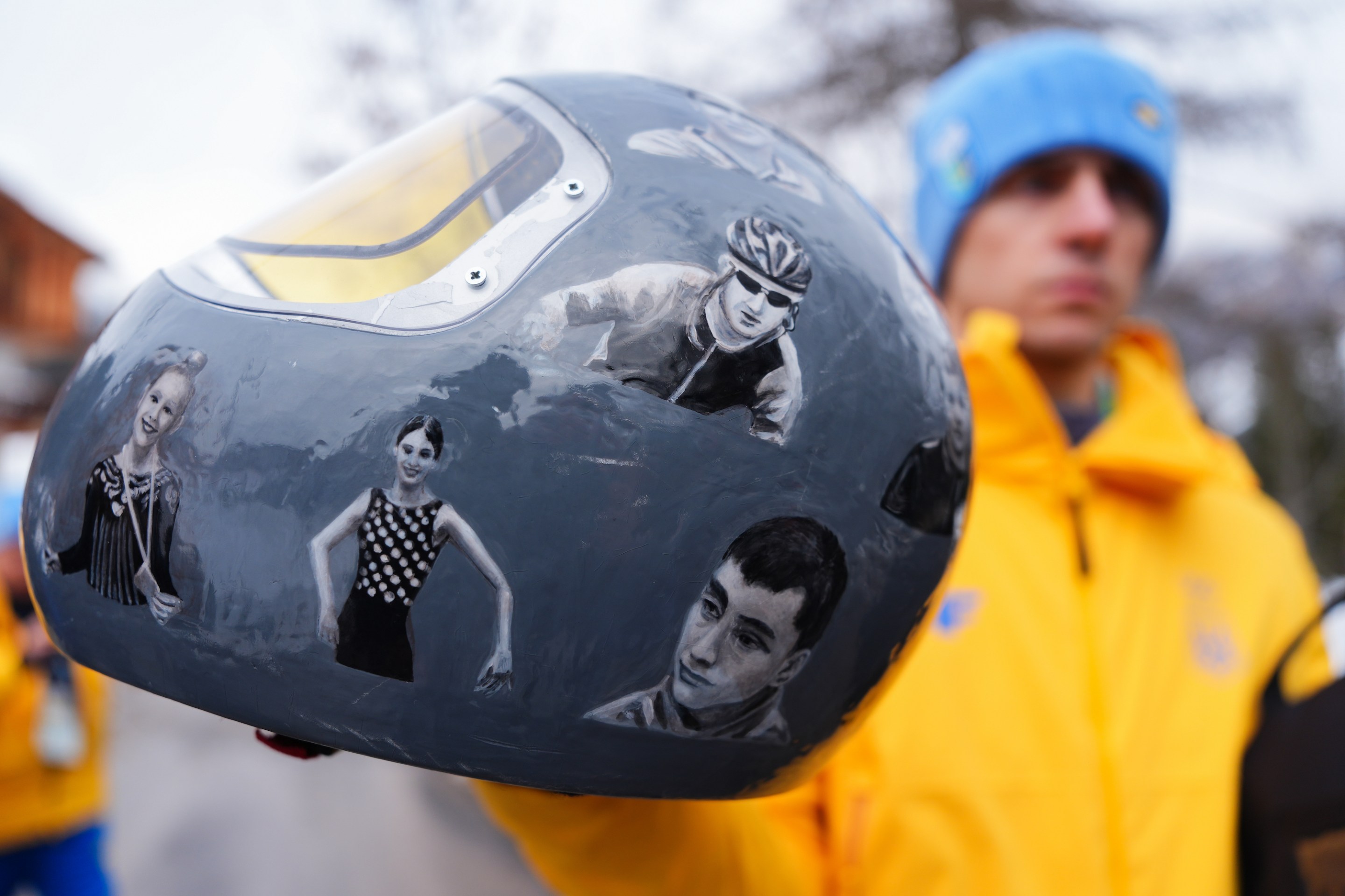 Ukraine's Vladyslav Heraskevych, with his helmet, which features pictures of people killed in the war with Russia.