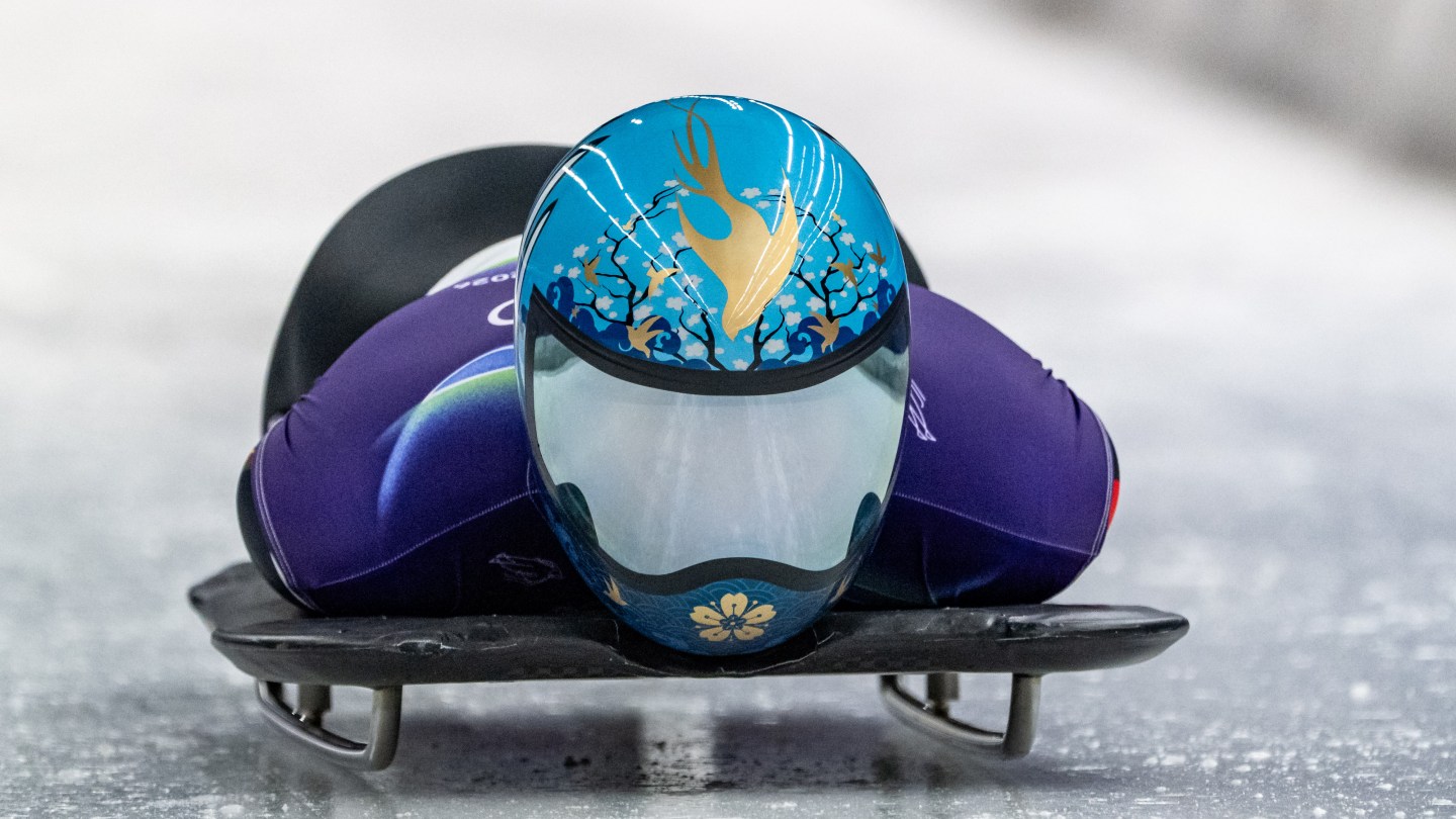 Dan Zhao of Team China wears a light blue helmet with a golden aquatic design.