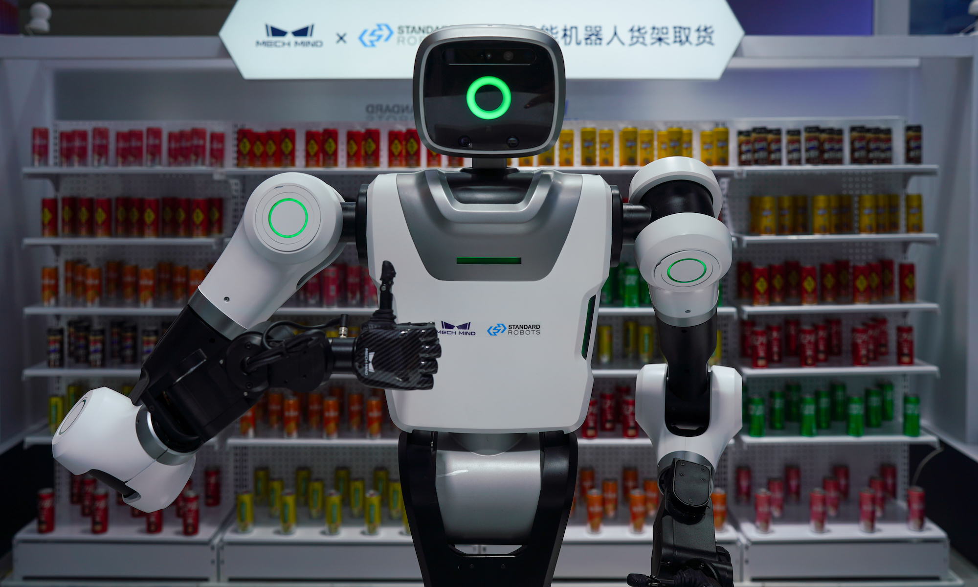Mech Mind automatic vending robot gives a thumbs-up after fetching beverages from a shelf at the exhibition area of the 2025 World AI Conference (WAIC) and High-Level Meeting on Global AI Governance on July 27, 2025 in Shanghai, China.